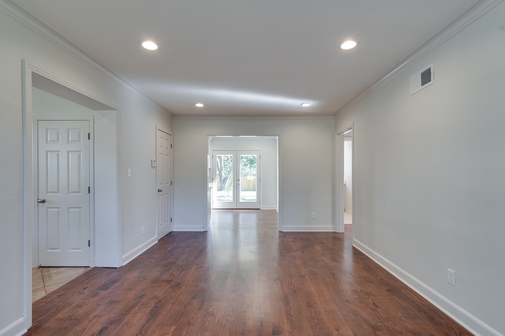 Spare room with dark hardwood / wood-style floors and ornamental molding