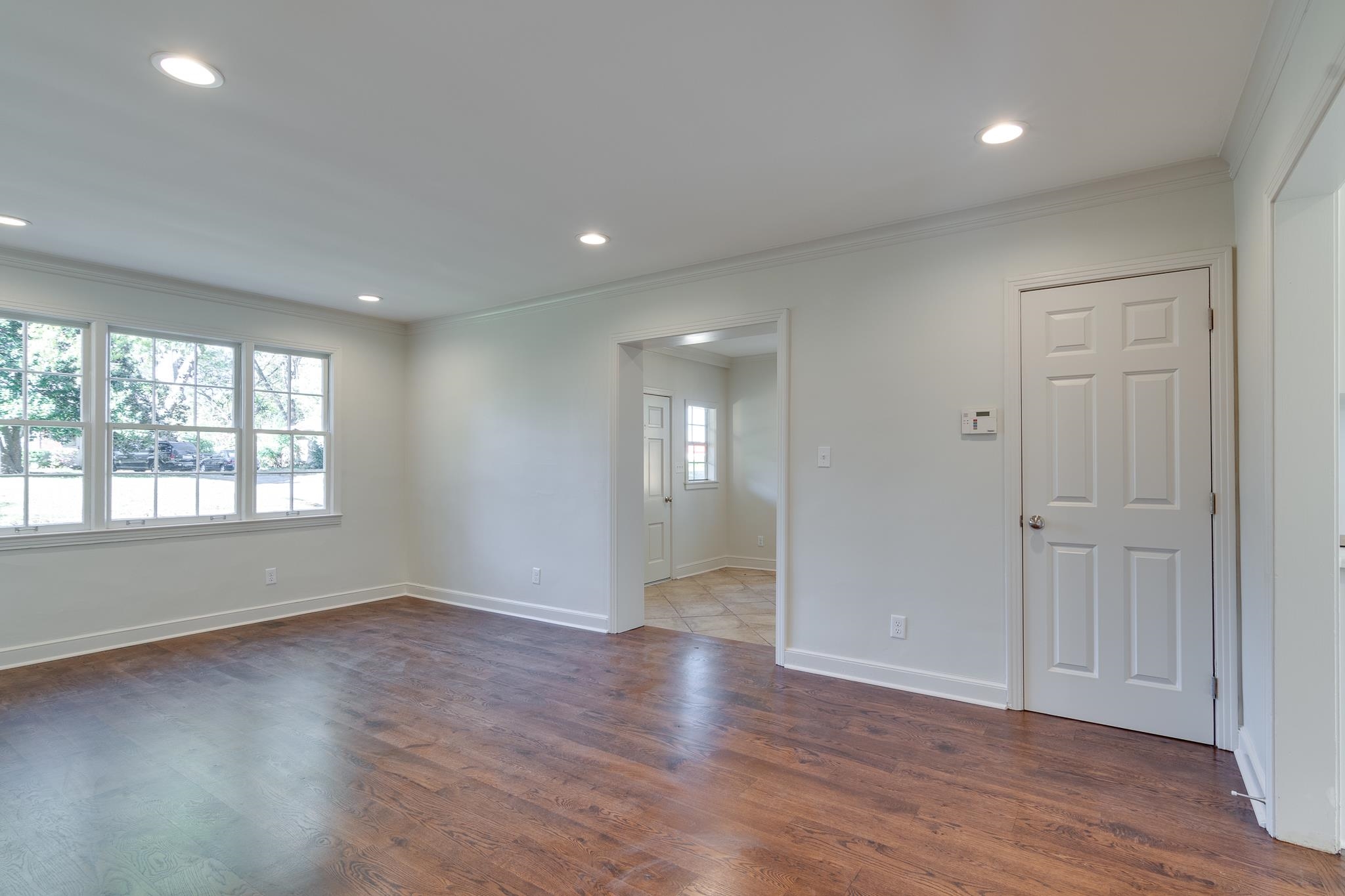 Unfurnished room with dark wood-type flooring and ornamental molding