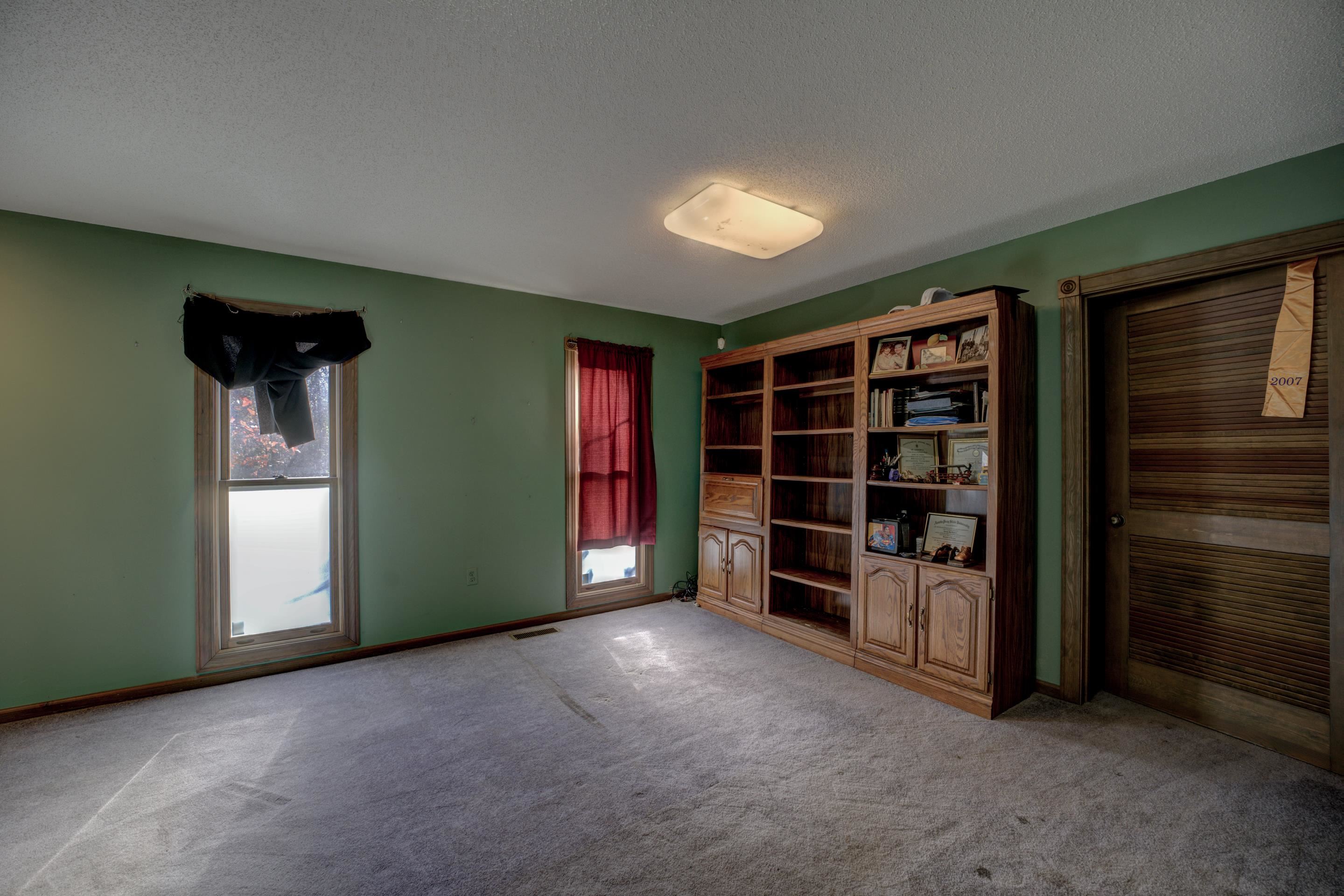 Carpeted empty room with a textured ceiling