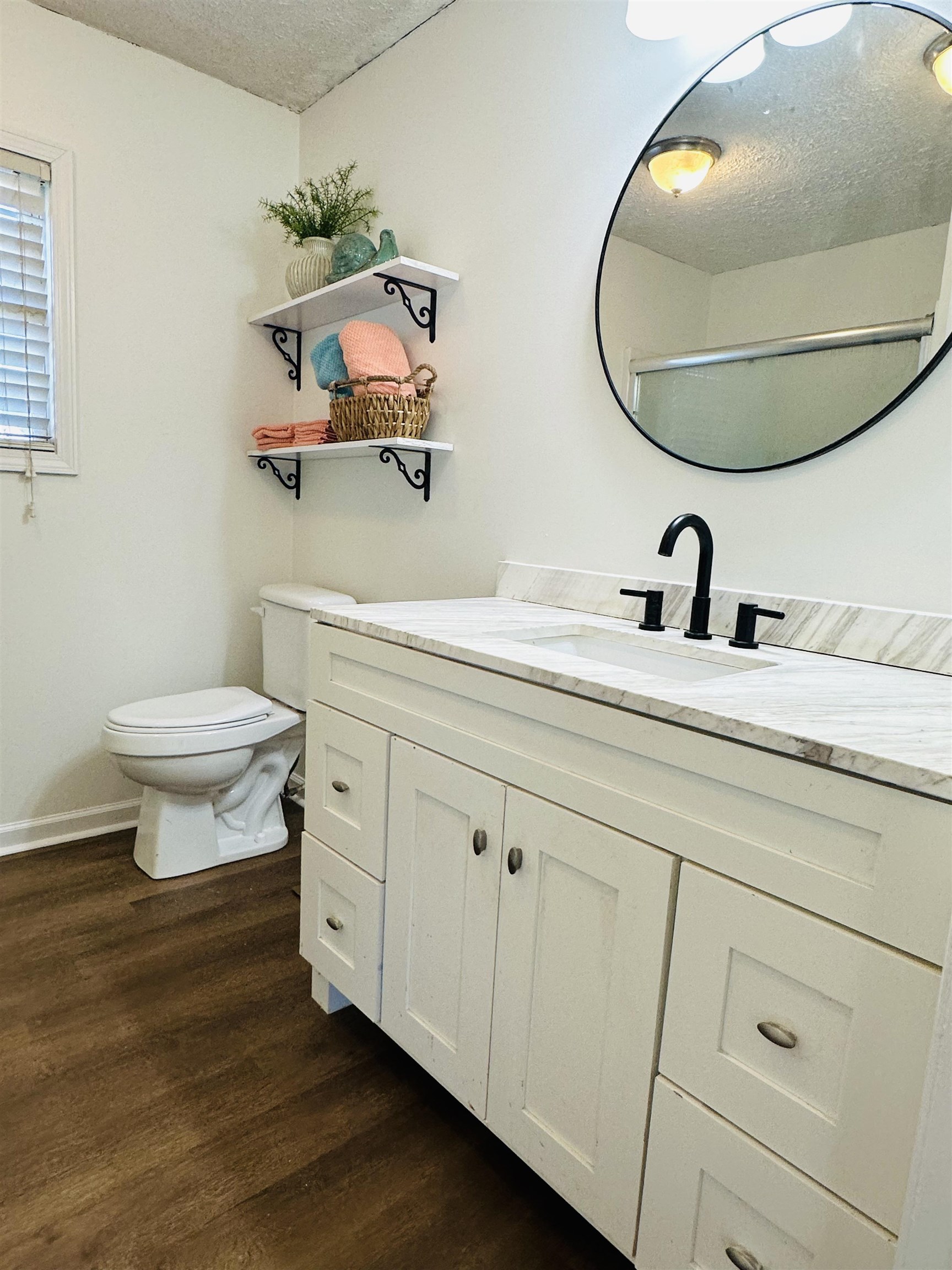 Bathroom featuring an enclosed shower, toilet, a textured ceiling, vanity, and hardwood / wood-style flooring