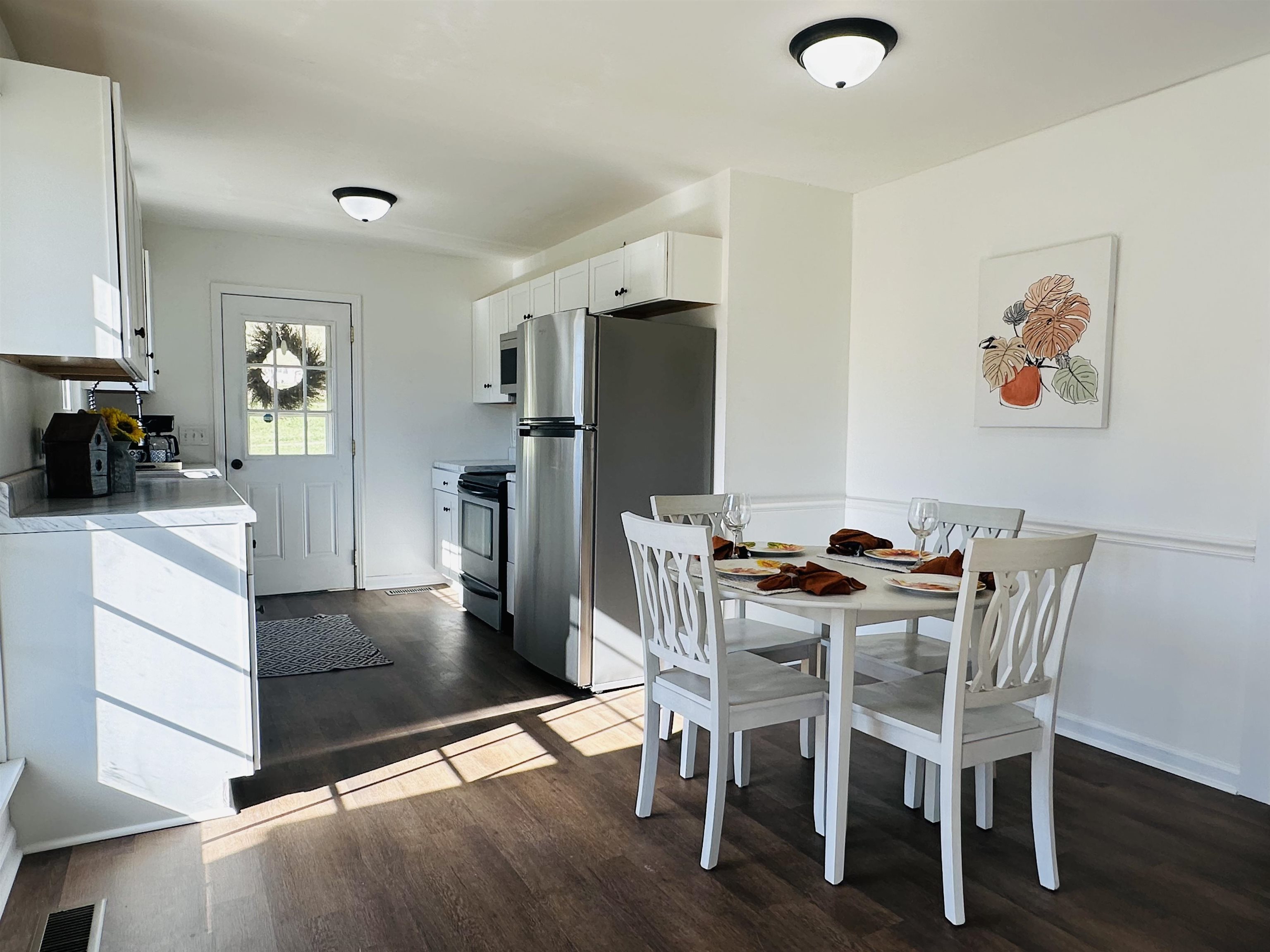 Dining area with dark wood-type flooring