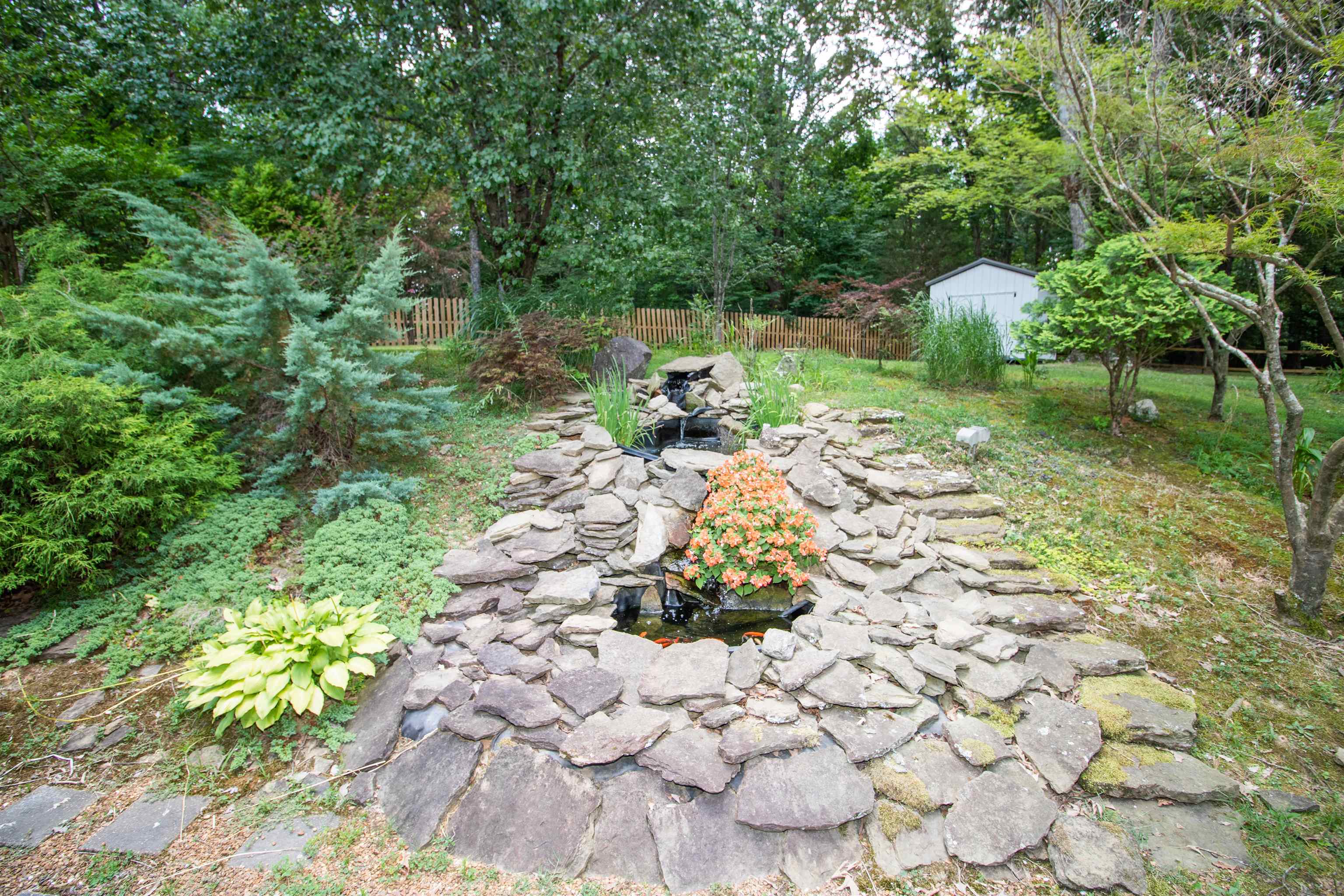 View of yard featuring a fire pit and a storage shed