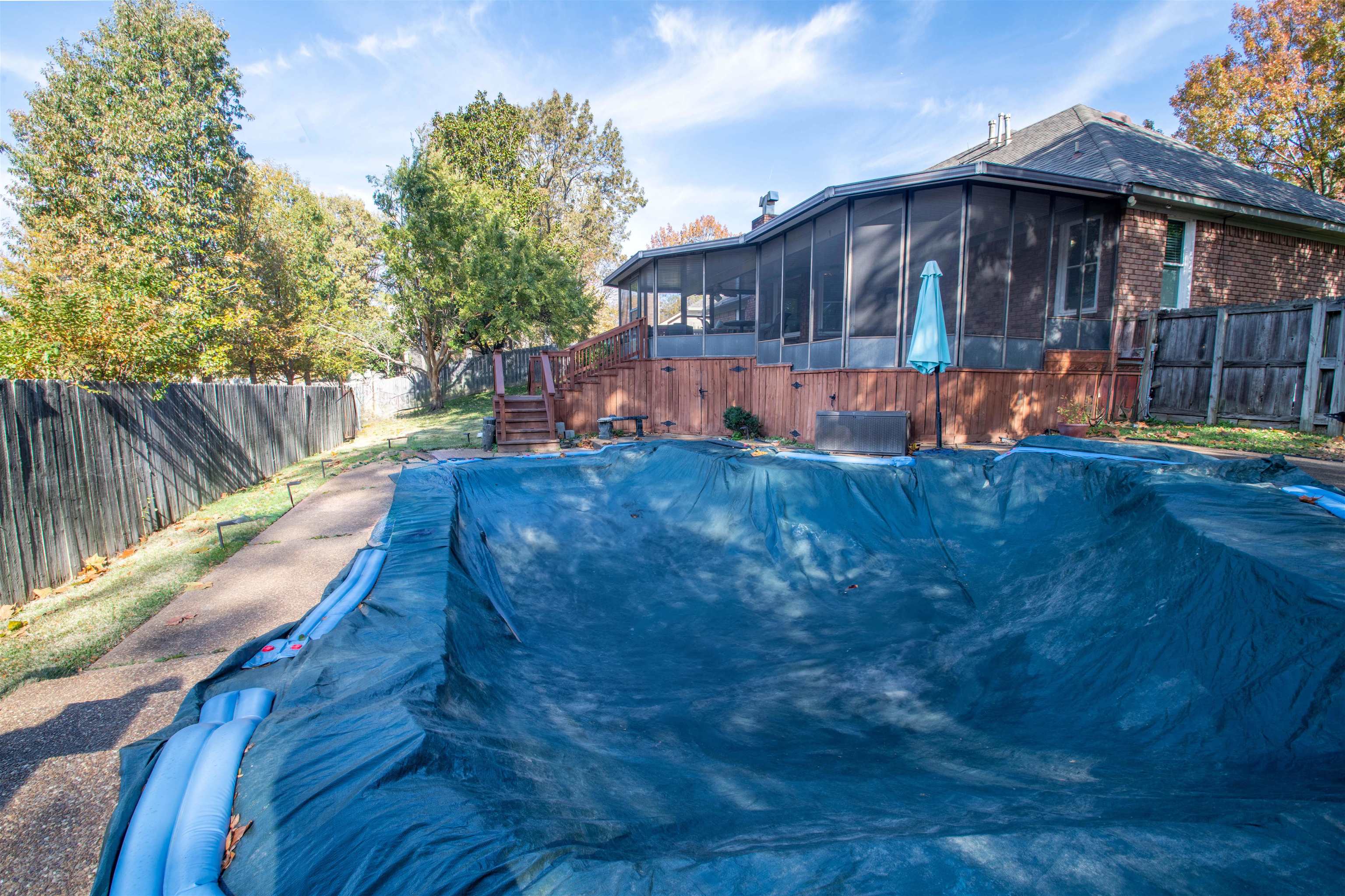 View of pool featuring a sunroom