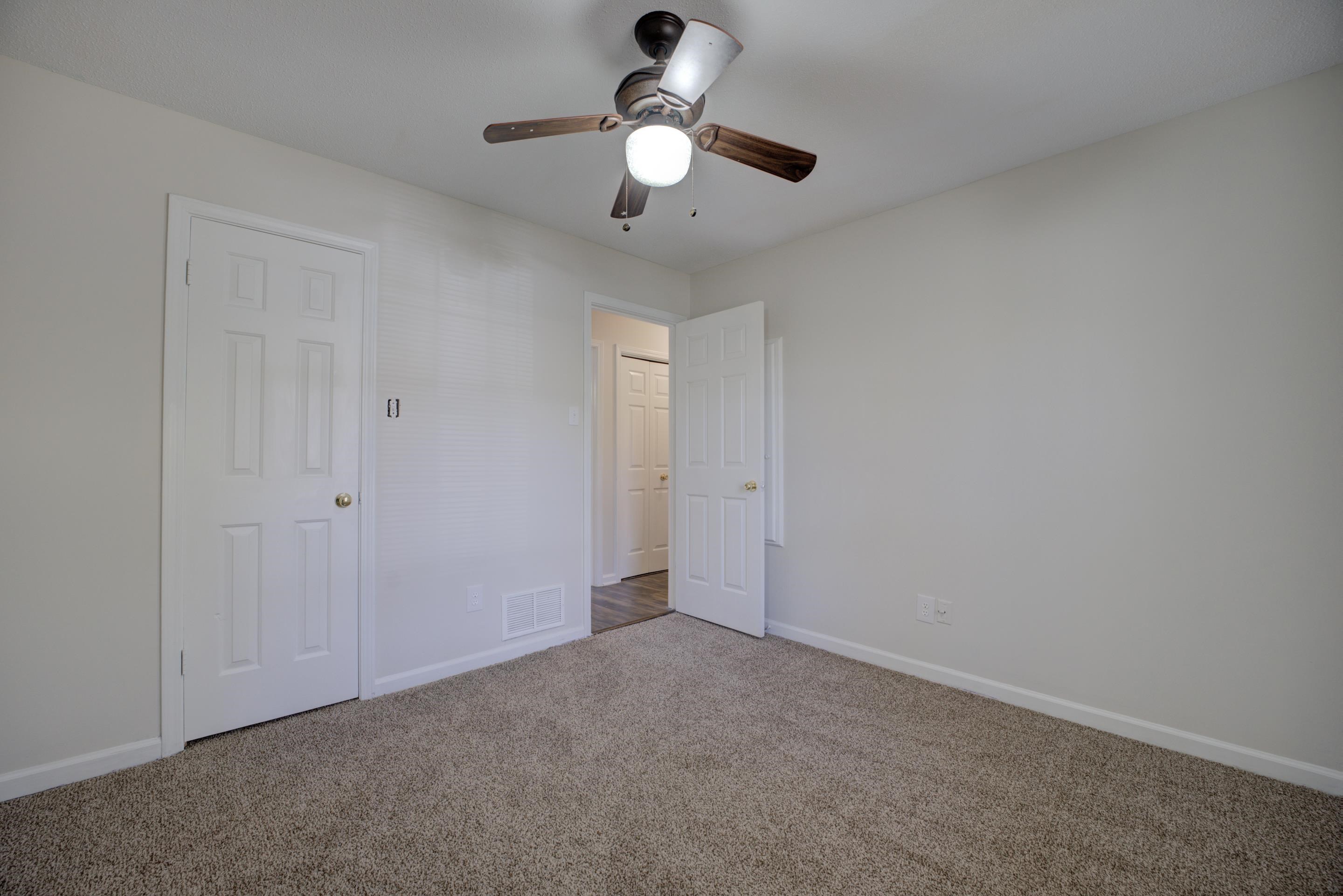 Unfurnished bedroom with carpet flooring and ceiling fan