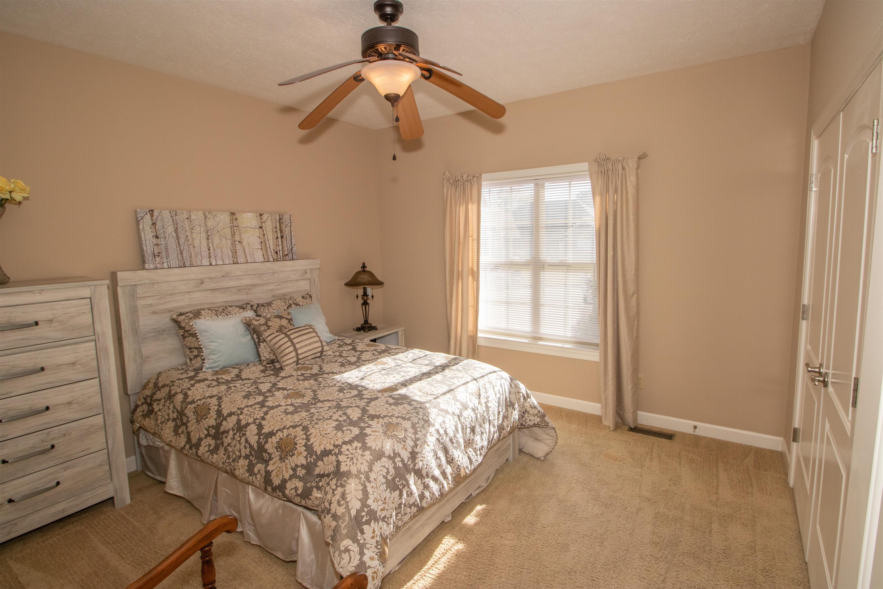 Bedroom featuring ceiling fan and light carpet