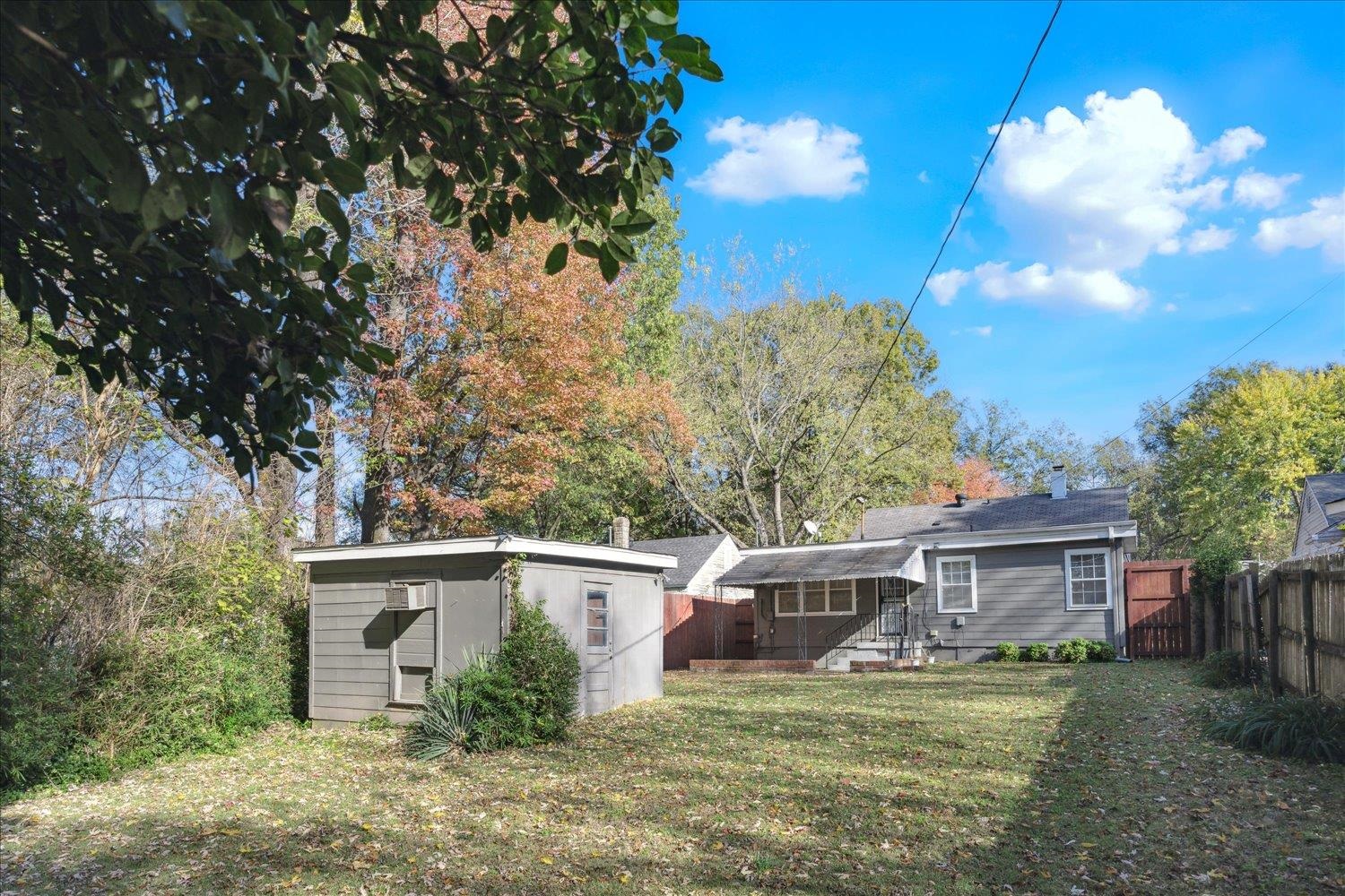 Rear view of house with a lawn