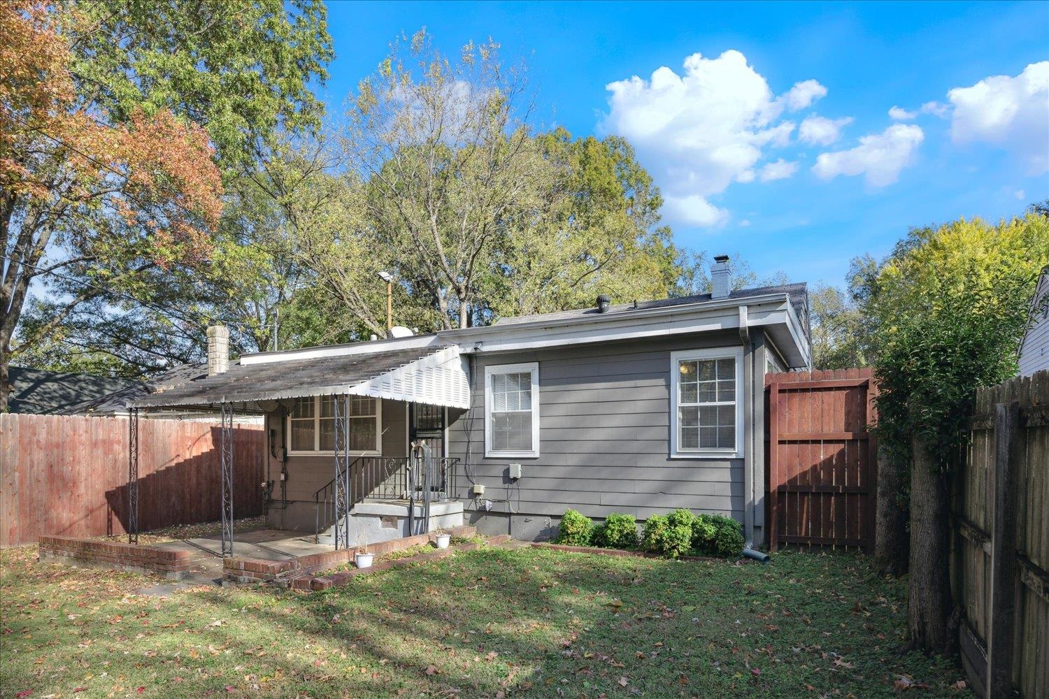 Rear view of house featuring a yard