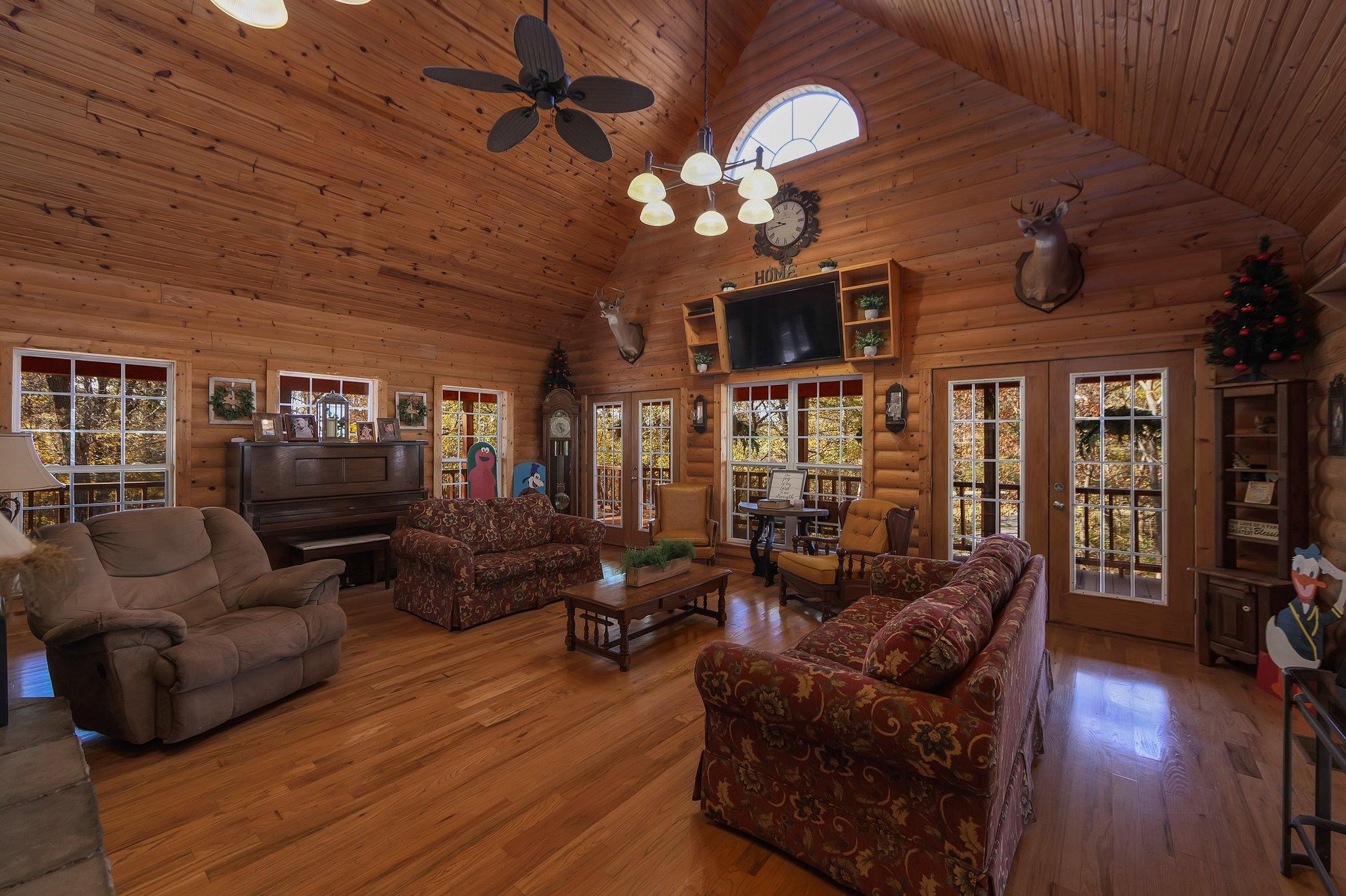 Living room featuring hardwood / wood-style flooring, high vaulted ceiling, and plenty of natural light