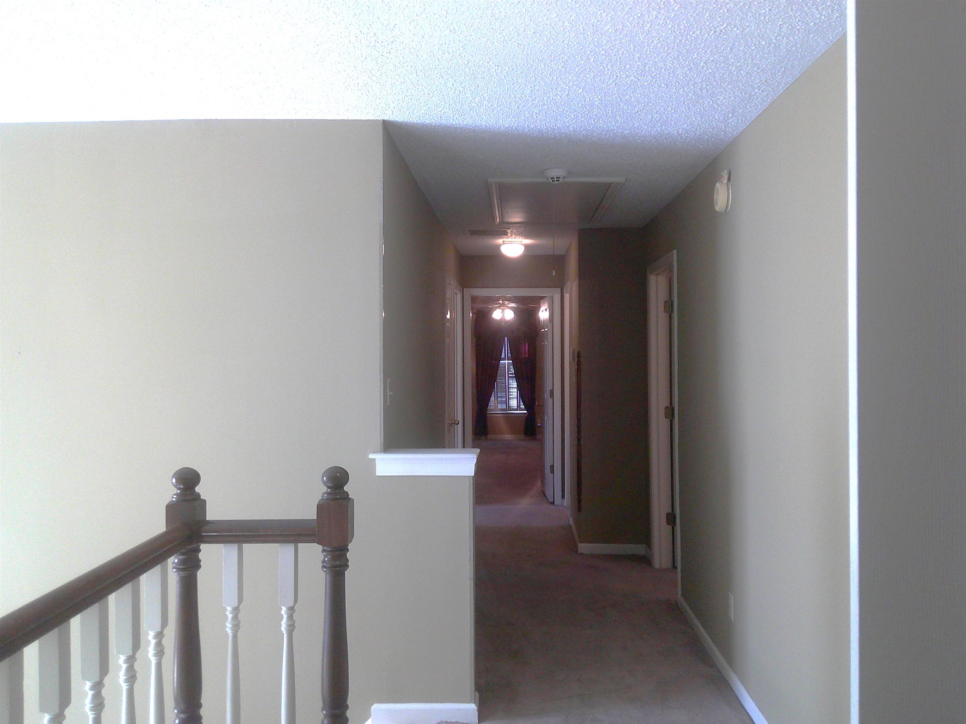 Corridor featuring a textured ceiling