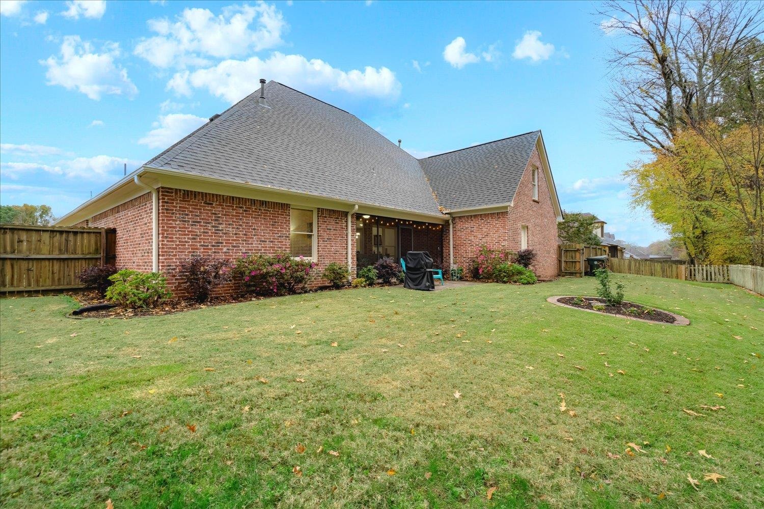 Rear view of house with a lawn