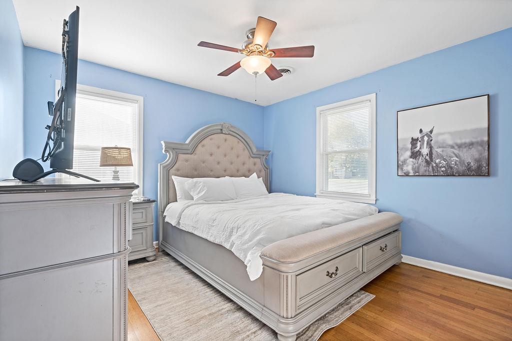 Bedroom featuring ceiling fan and light hardwood / wood-style flooring