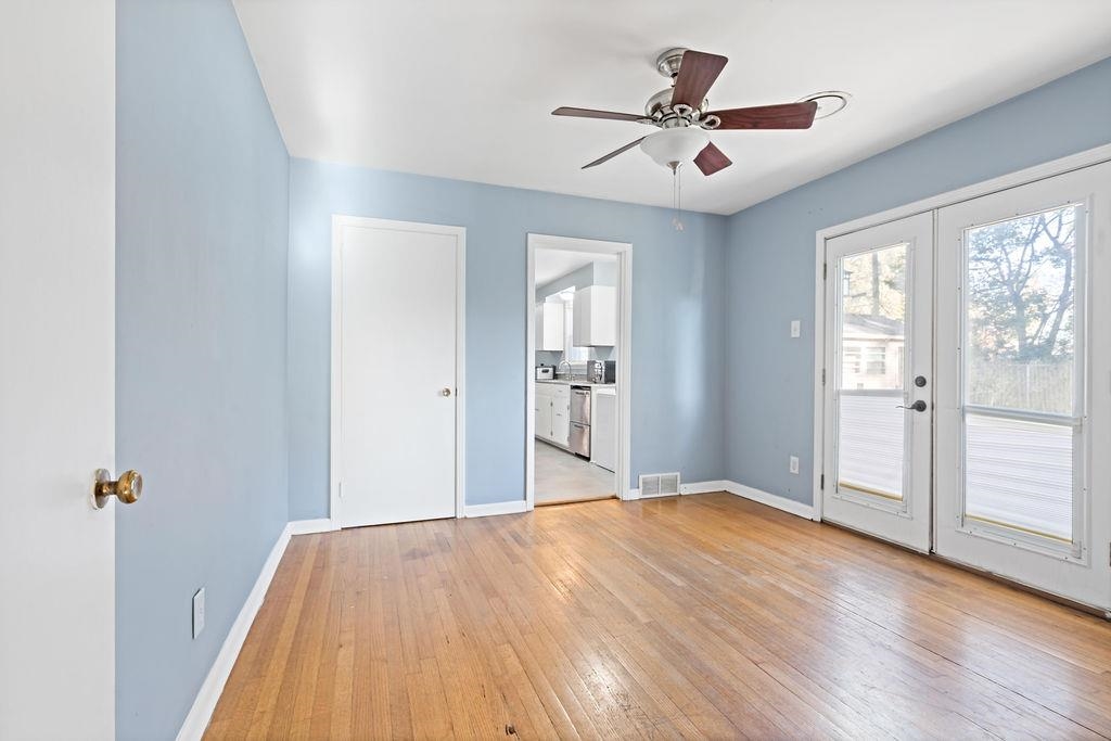 Unfurnished room featuring french doors, light hardwood / wood-style flooring, and ceiling fan