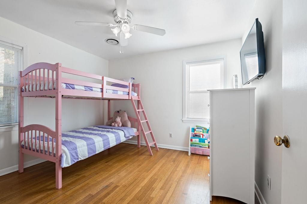 Bedroom with ceiling fan and wood-type flooring