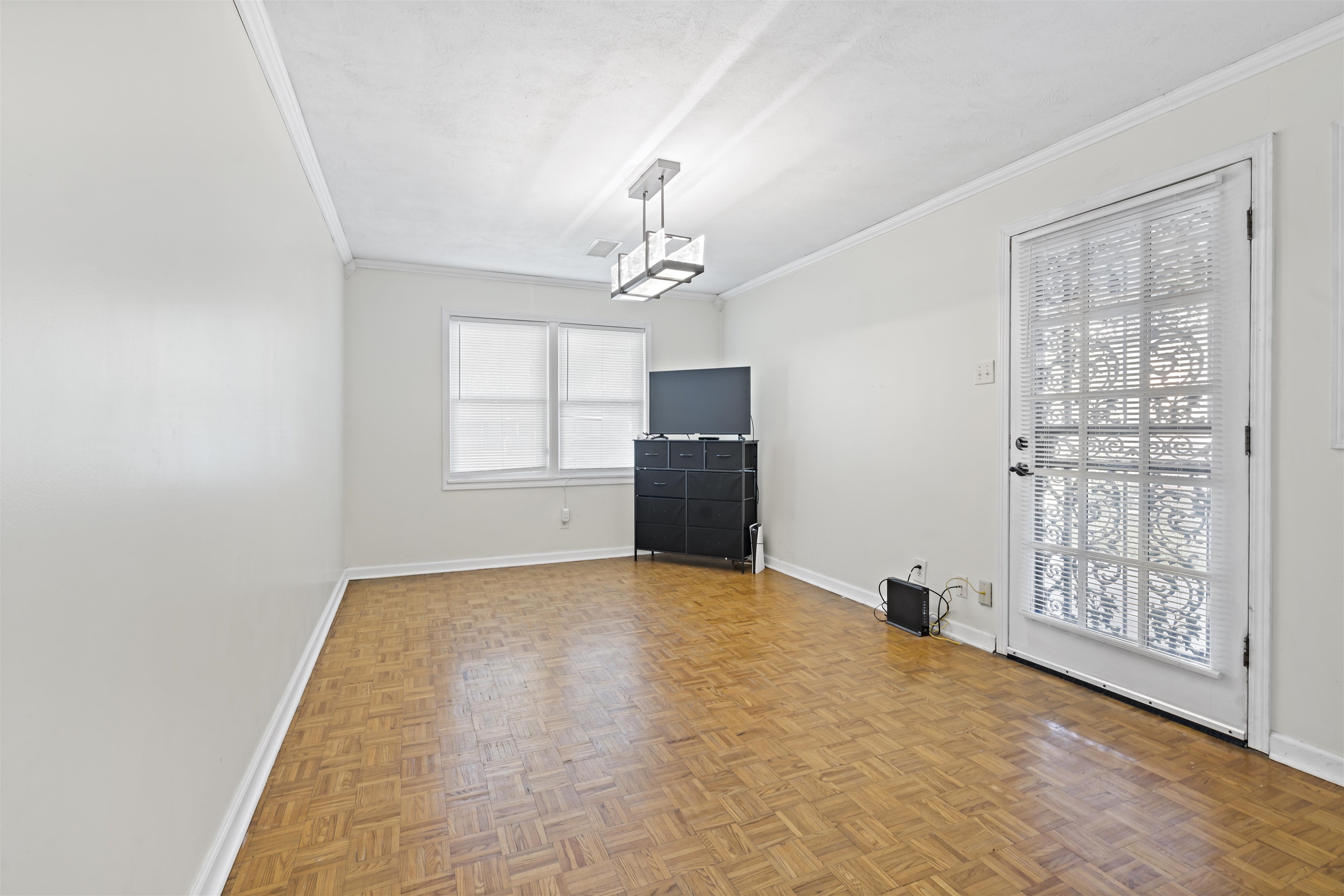 Interior space featuring parquet floors and crown molding