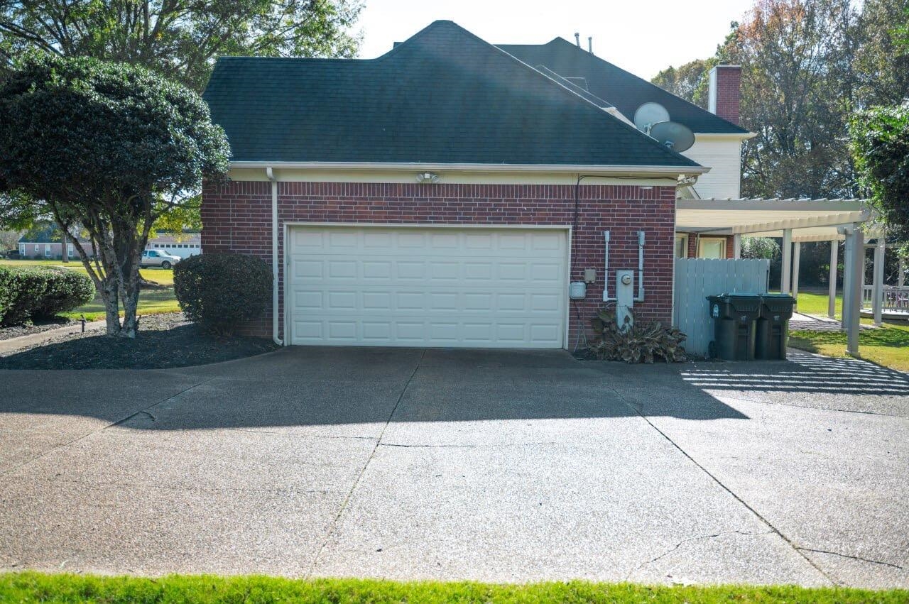 View of property exterior featuring a garage