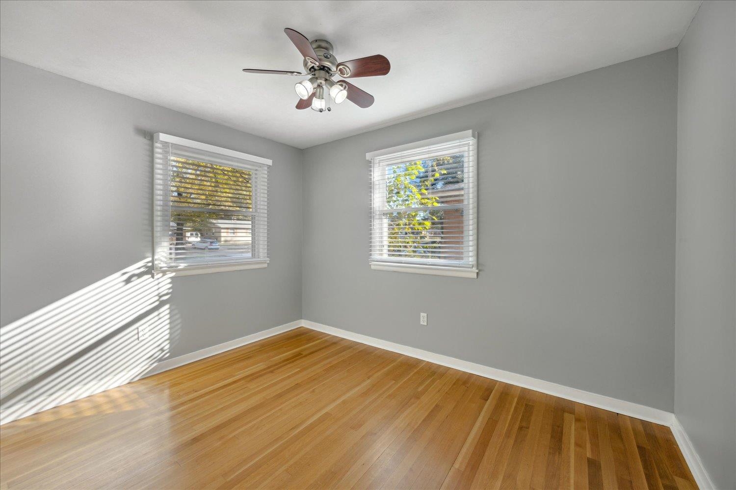 Unfurnished room with ceiling fan and wood-type flooring