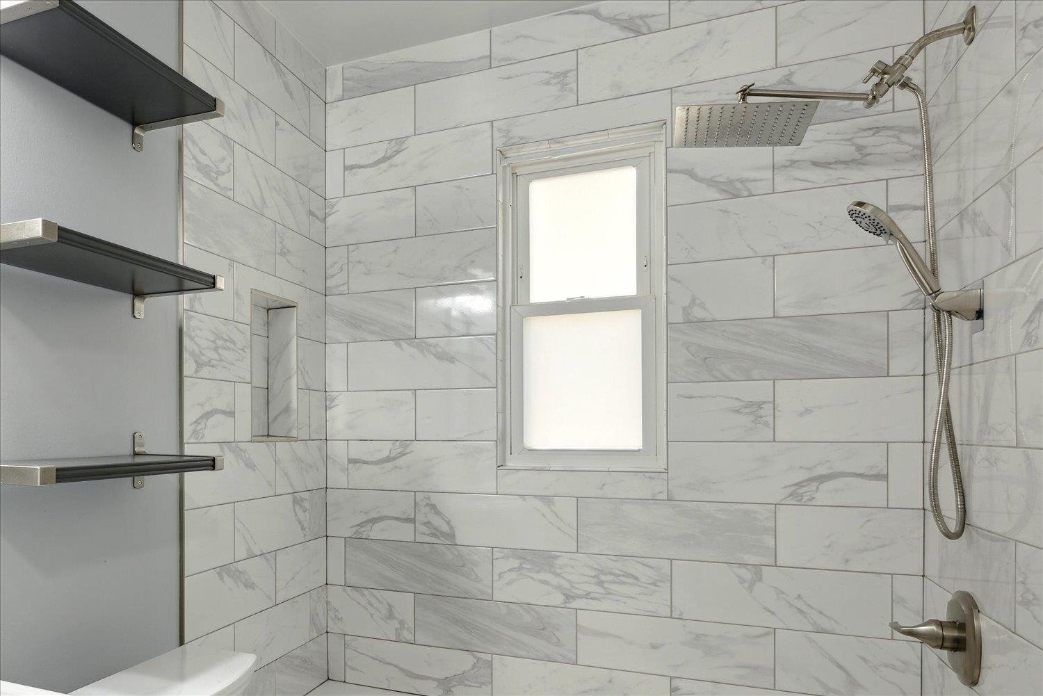 Bathroom with a tile shower and toilet