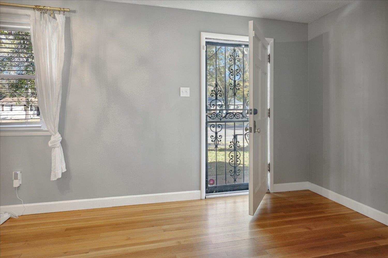 Entrance foyer with hardwood / wood-style flooring and a healthy amount of sunlight