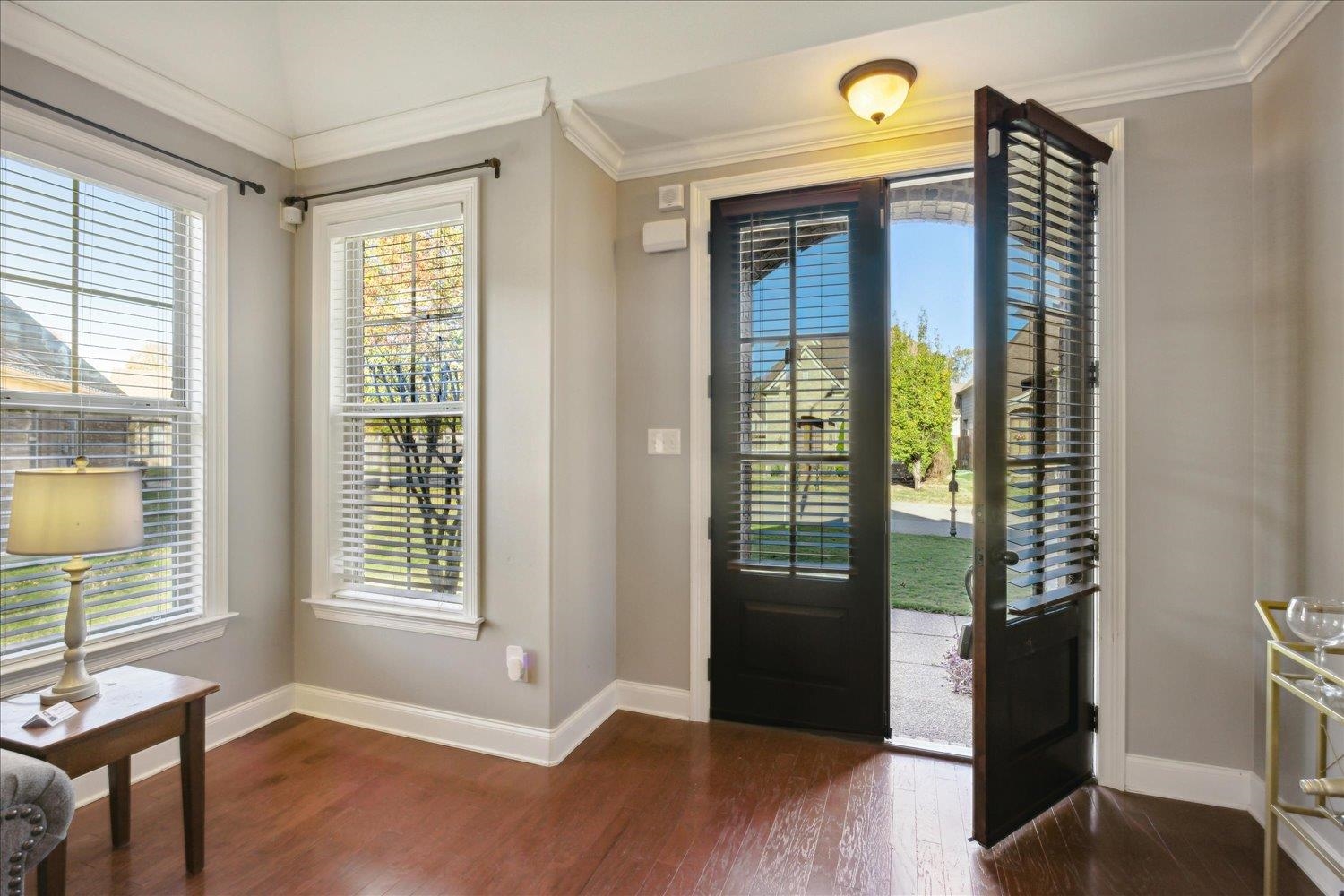 Entrance foyer featuring dark hardwood / wood-style floors and ornamental molding