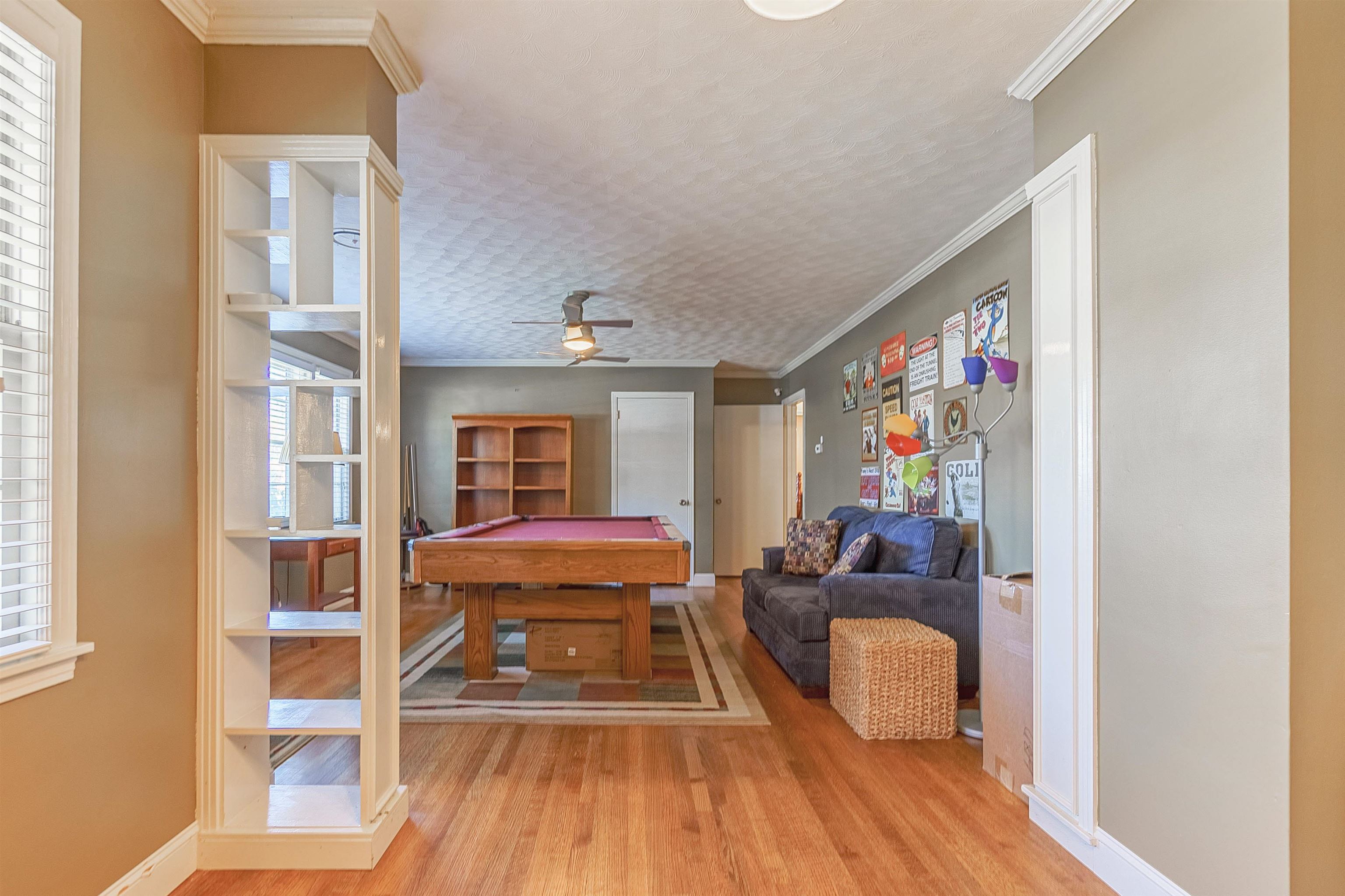 Playroom featuring ceiling fan, crown molding, billiards, and light wood-type flooring