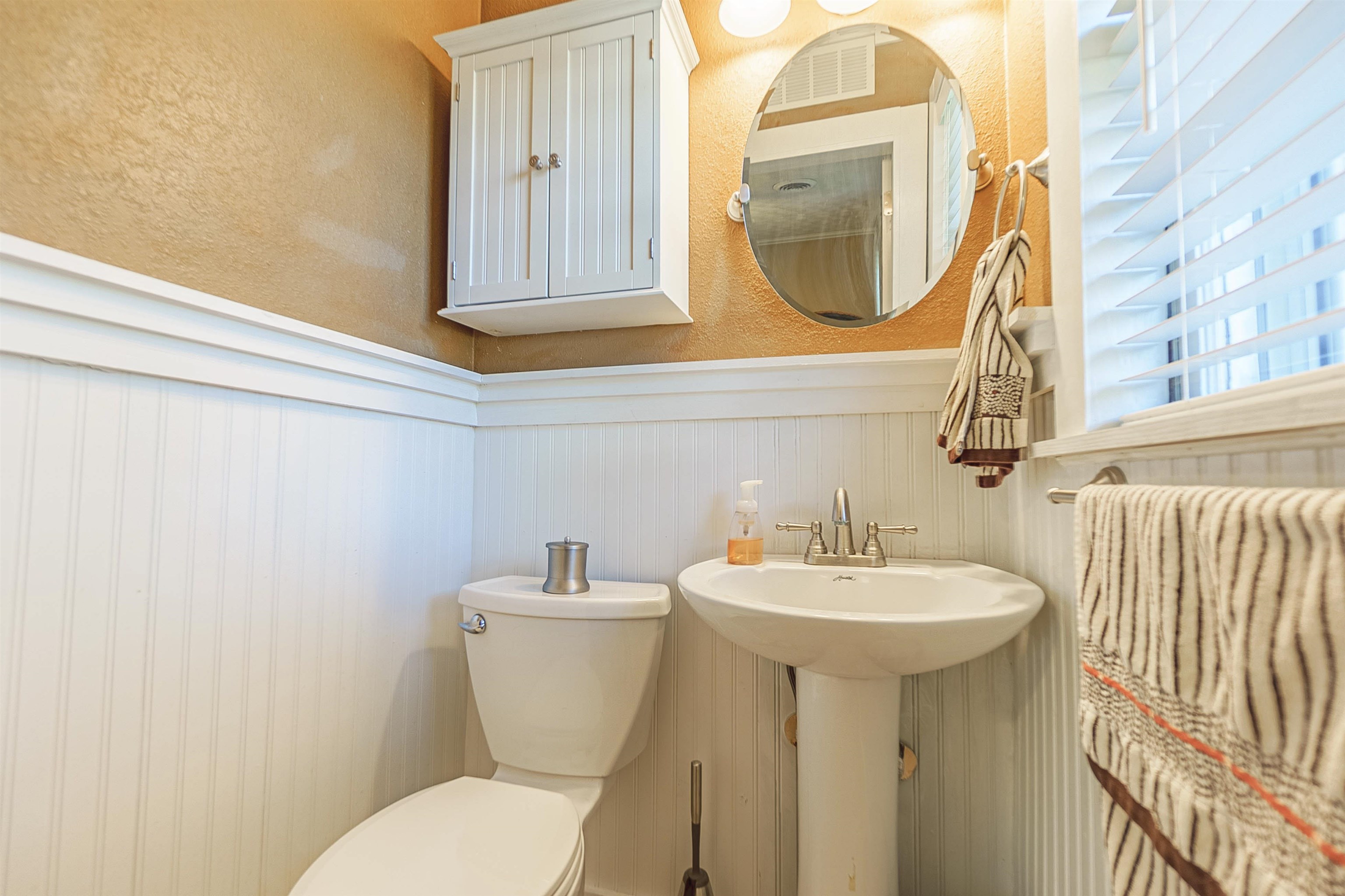 Bathroom with wood walls, toilet, and sink