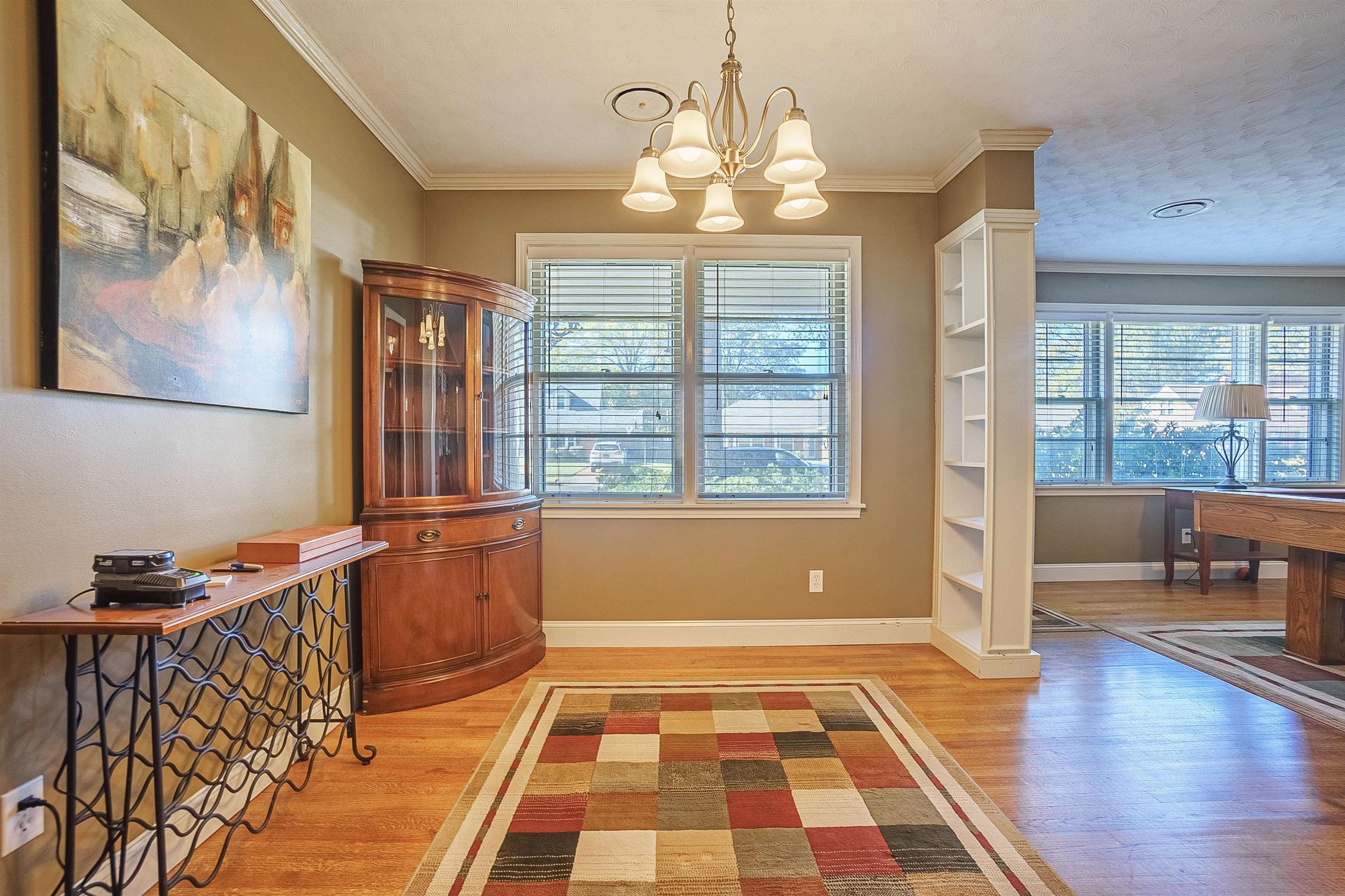 Dining space featuring hardwood / wood-style flooring, ornamental molding, and a wealth of natural light