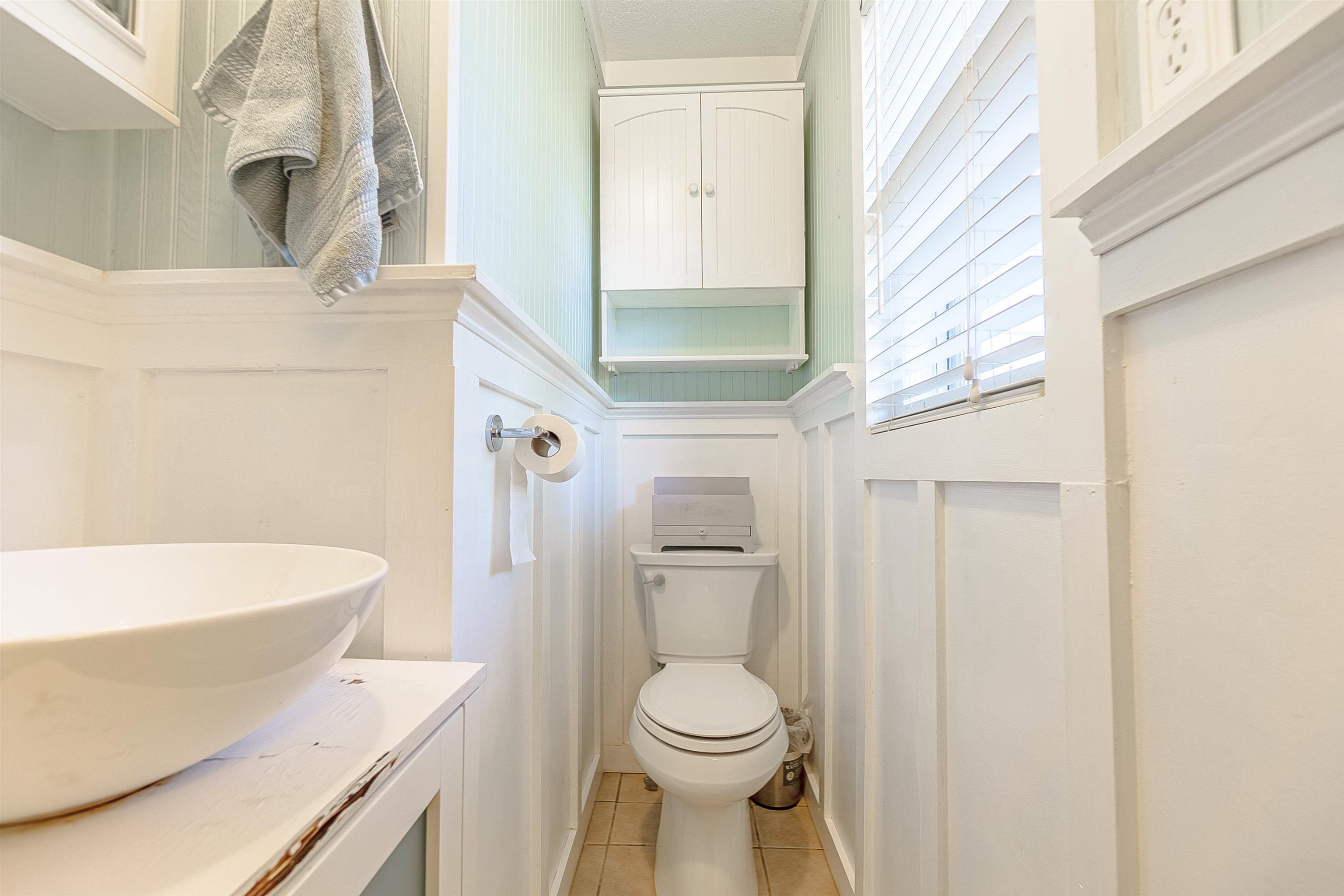 Bathroom featuring tile patterned floors, vanity, and toilet