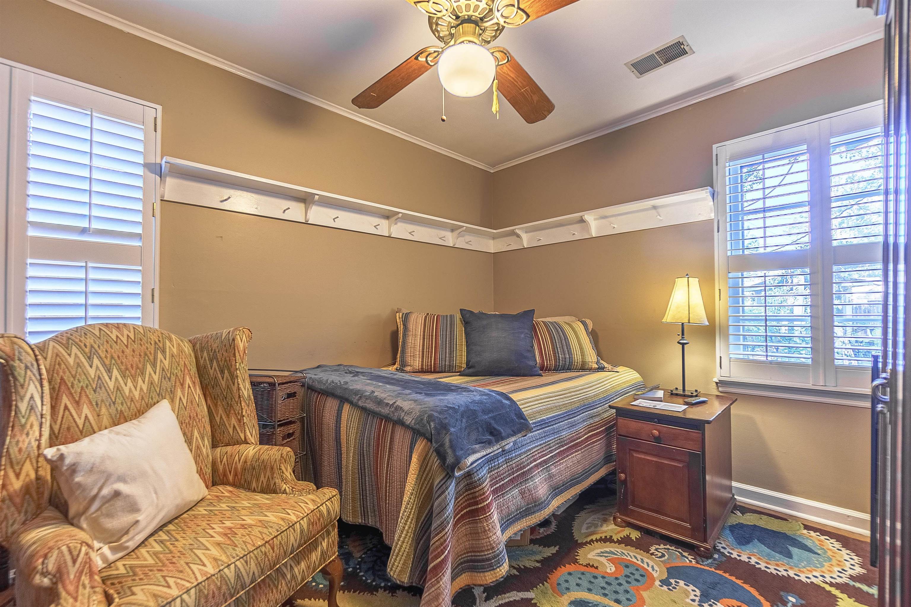 Bedroom with ceiling fan and crown molding