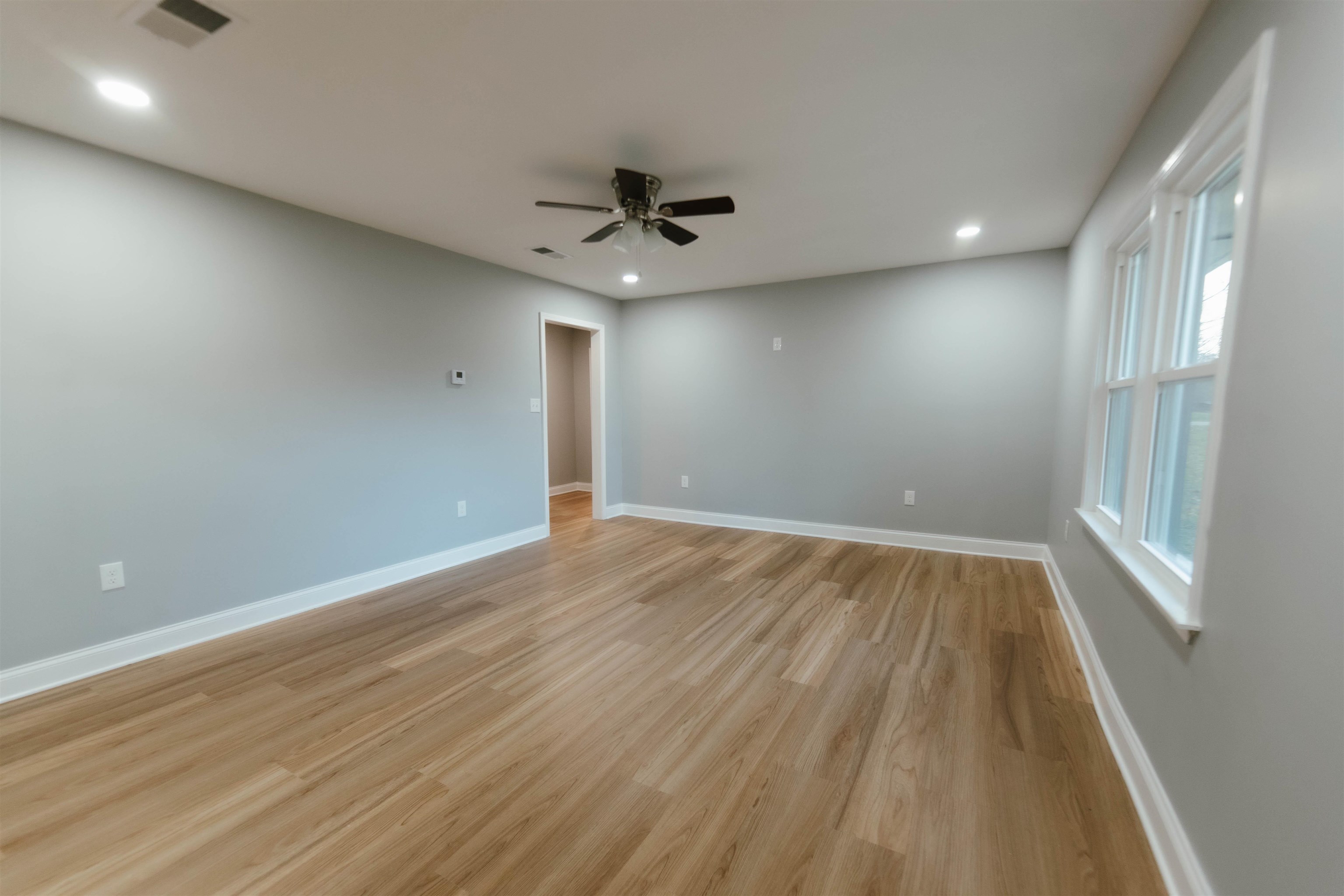 Unfurnished room featuring ceiling fan and light hardwood / wood-style floors