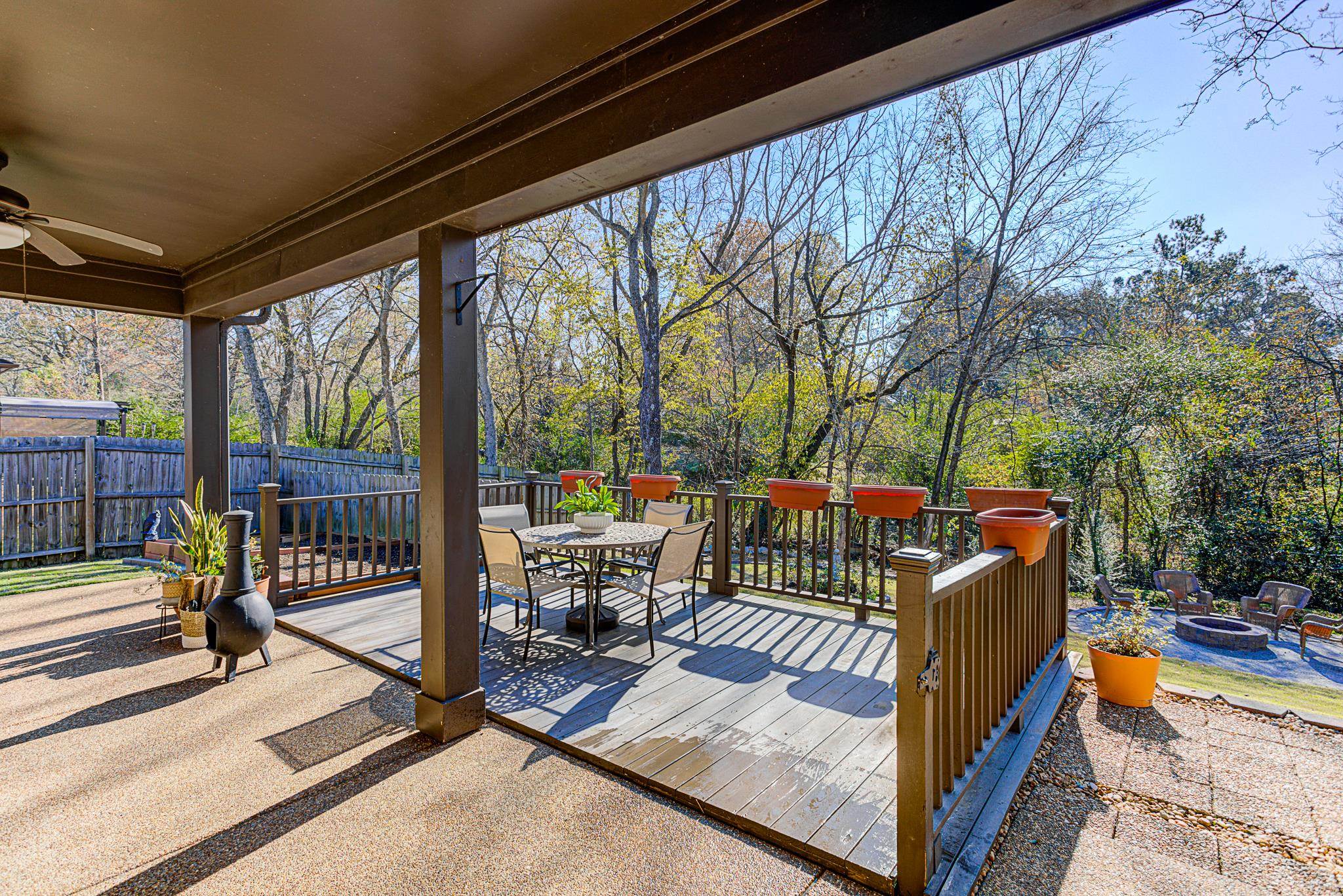 Wooden terrace featuring ceiling fan and an outdoor fire pit