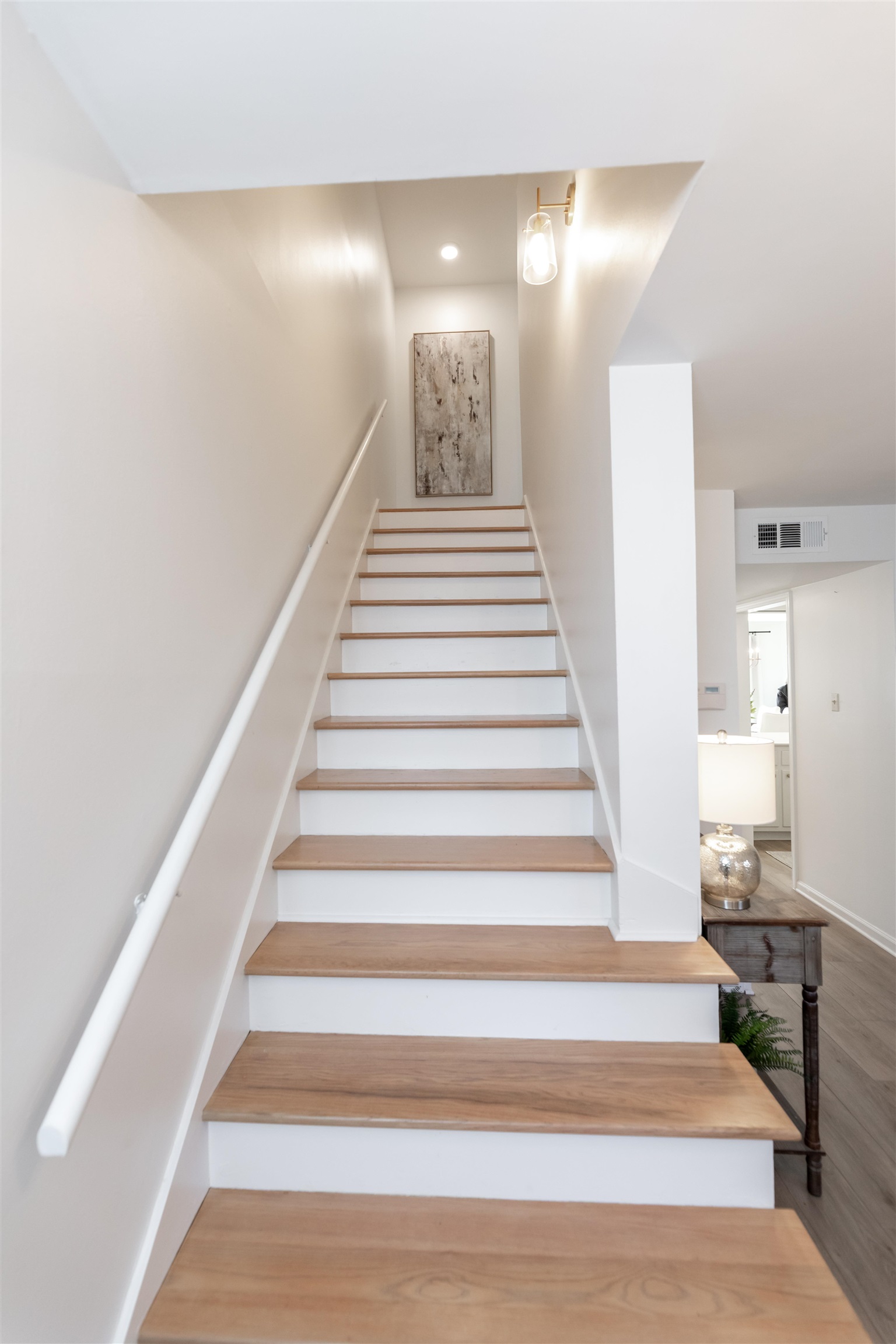 Stairs featuring hardwood / wood-style floors