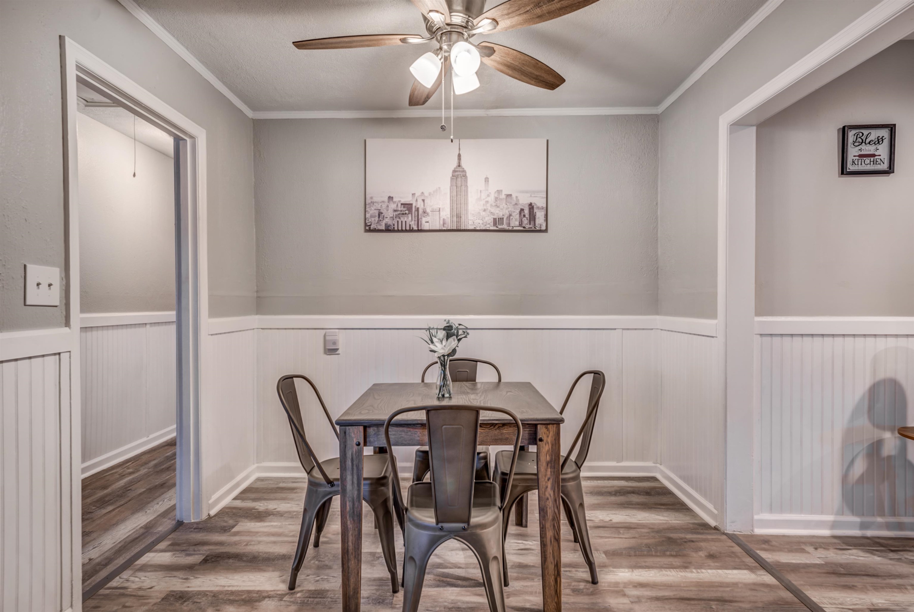 Dining space featuring ceiling fan, wood-type flooring, and ornamental molding