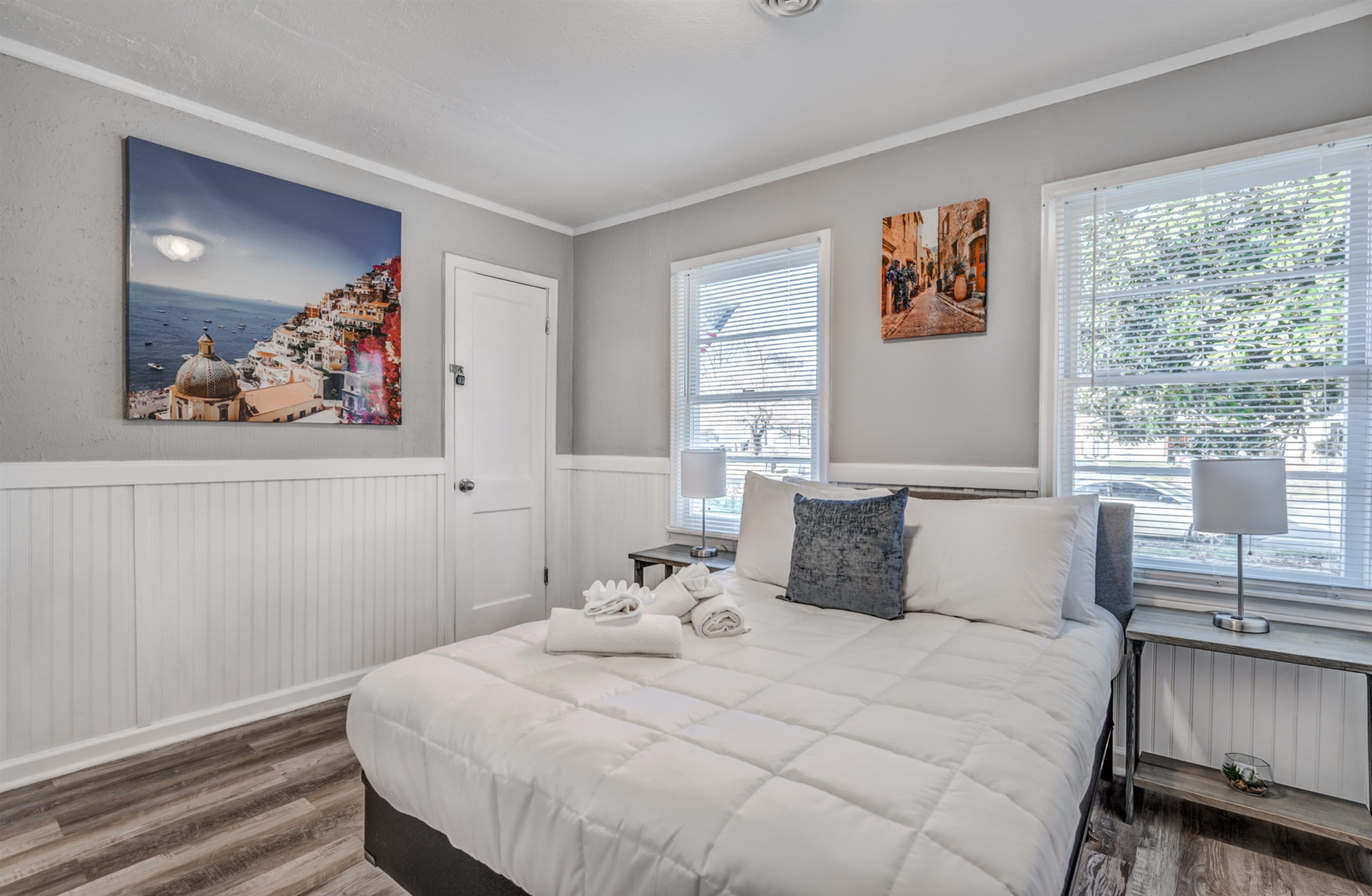 Bedroom with radiator heating unit, wood-type flooring, and ornamental molding