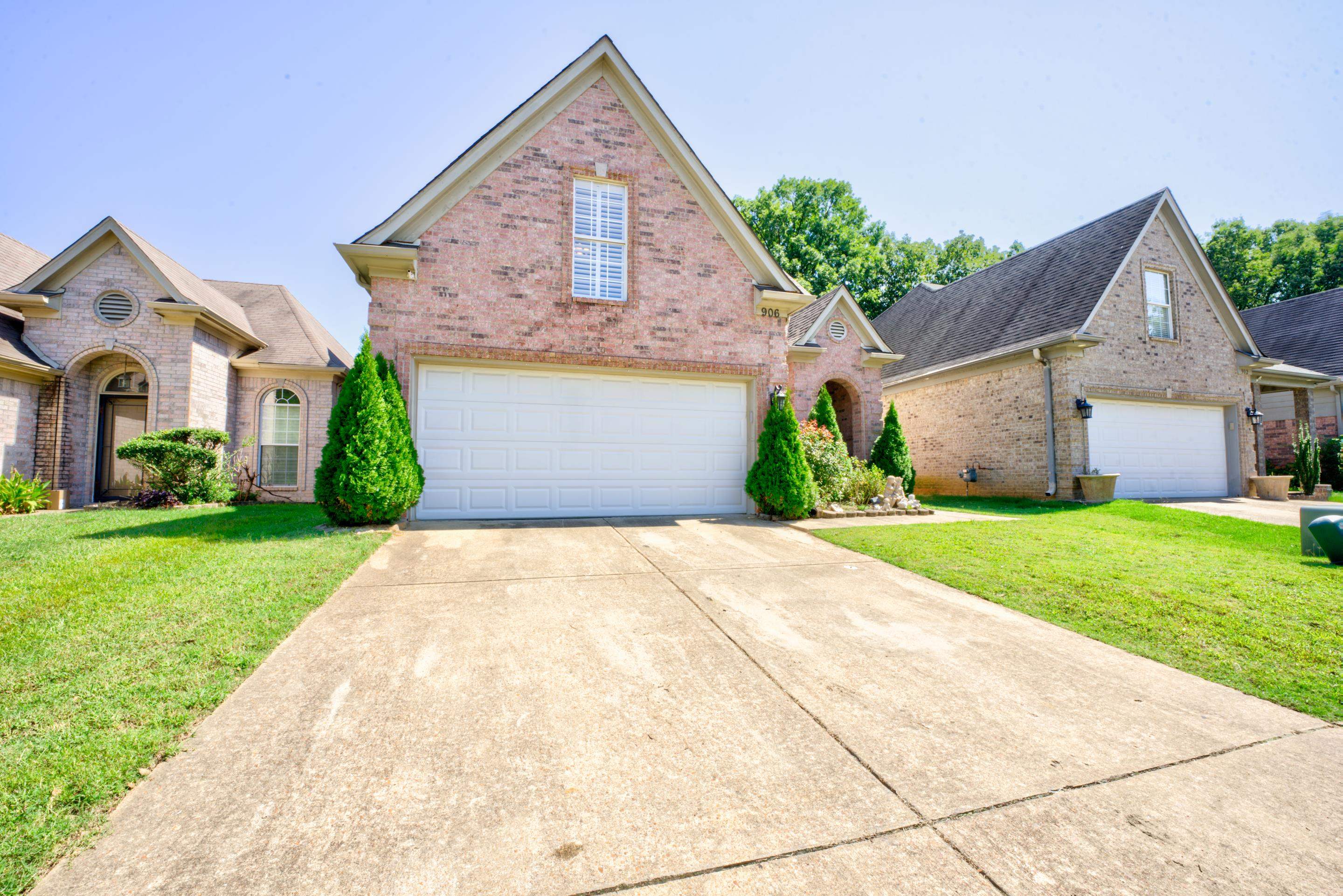 Front of property with a garage and a front lawn