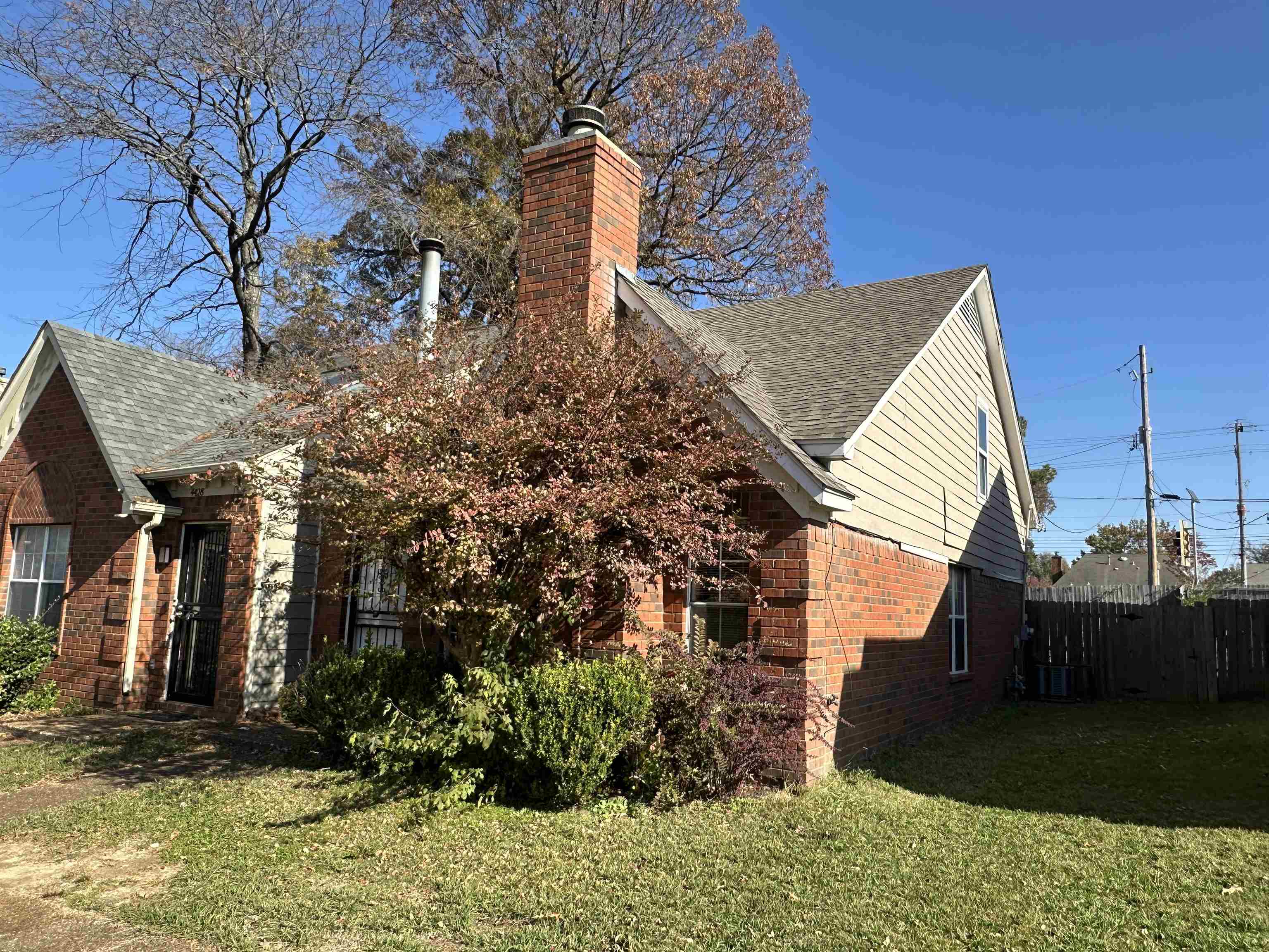 View of property exterior featuring a lawn