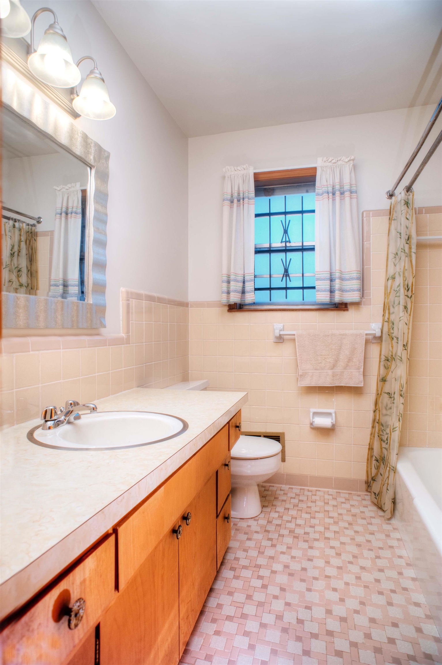 Full bathroom with vanity, toilet, tile walls, and shower / bath combo with shower curtain