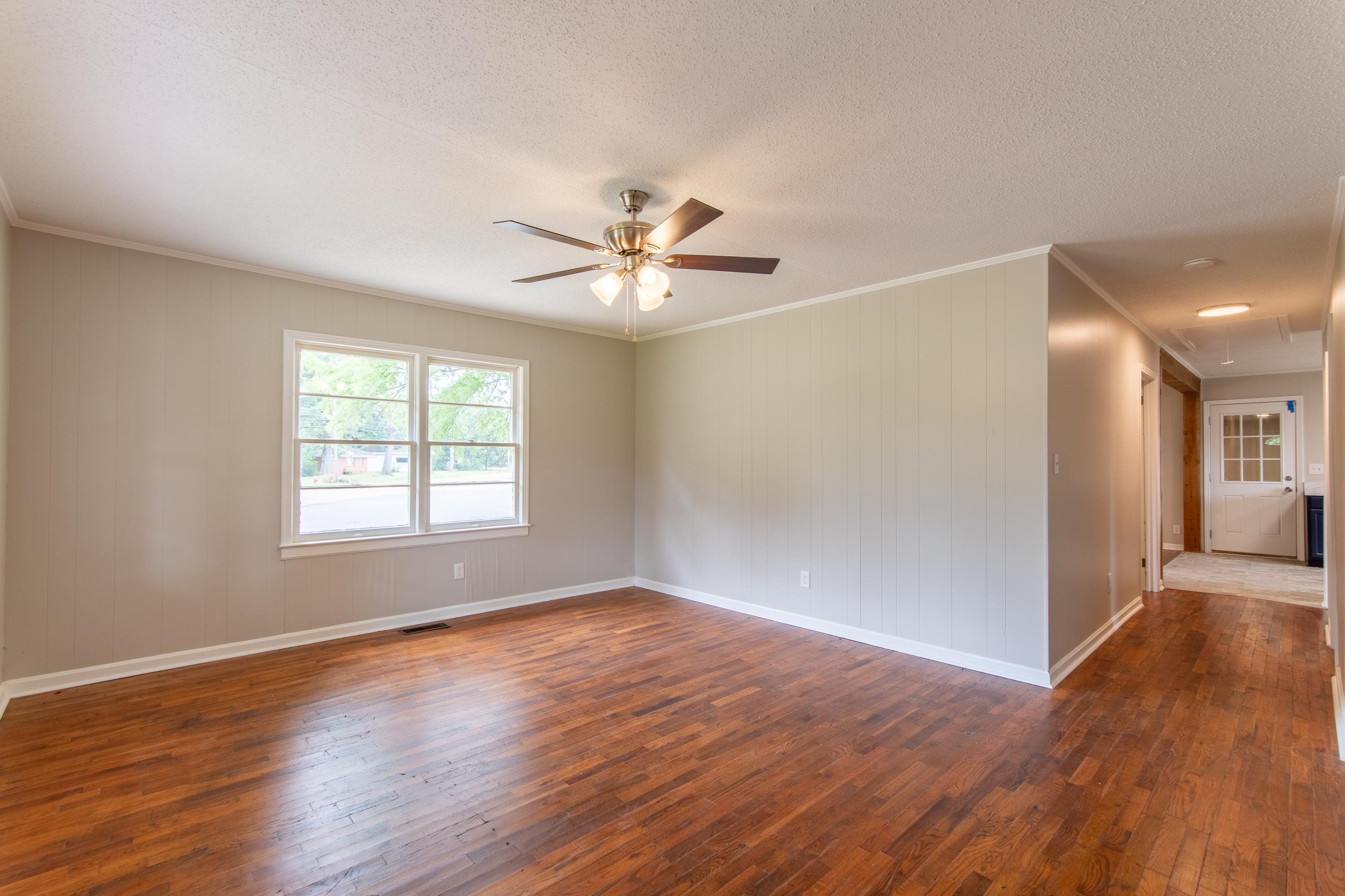 Spare room featuring ceiling fan, a textured ceiling, and hardwood / wood-style flooring