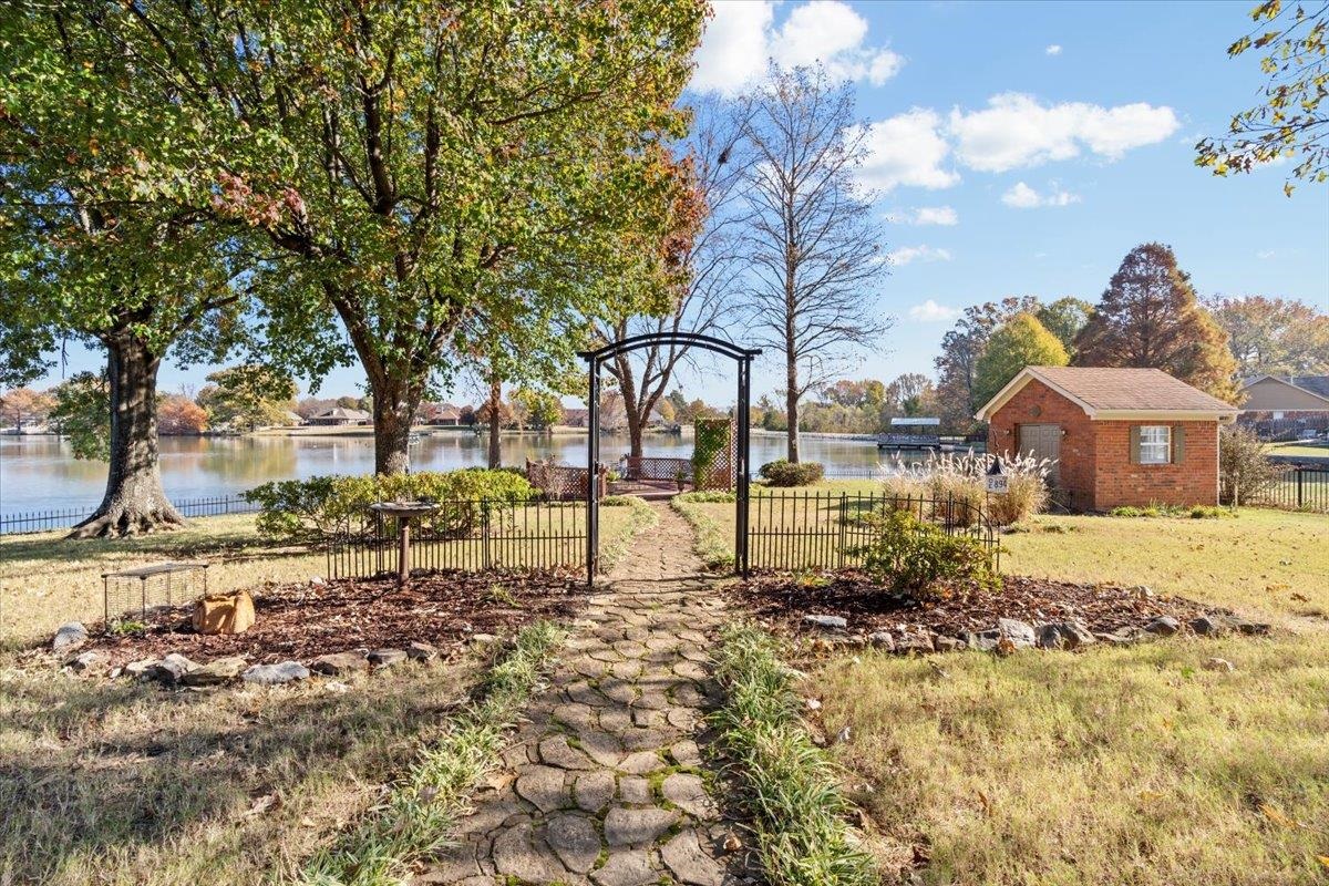 View of yard featuring a water view and an outbuilding