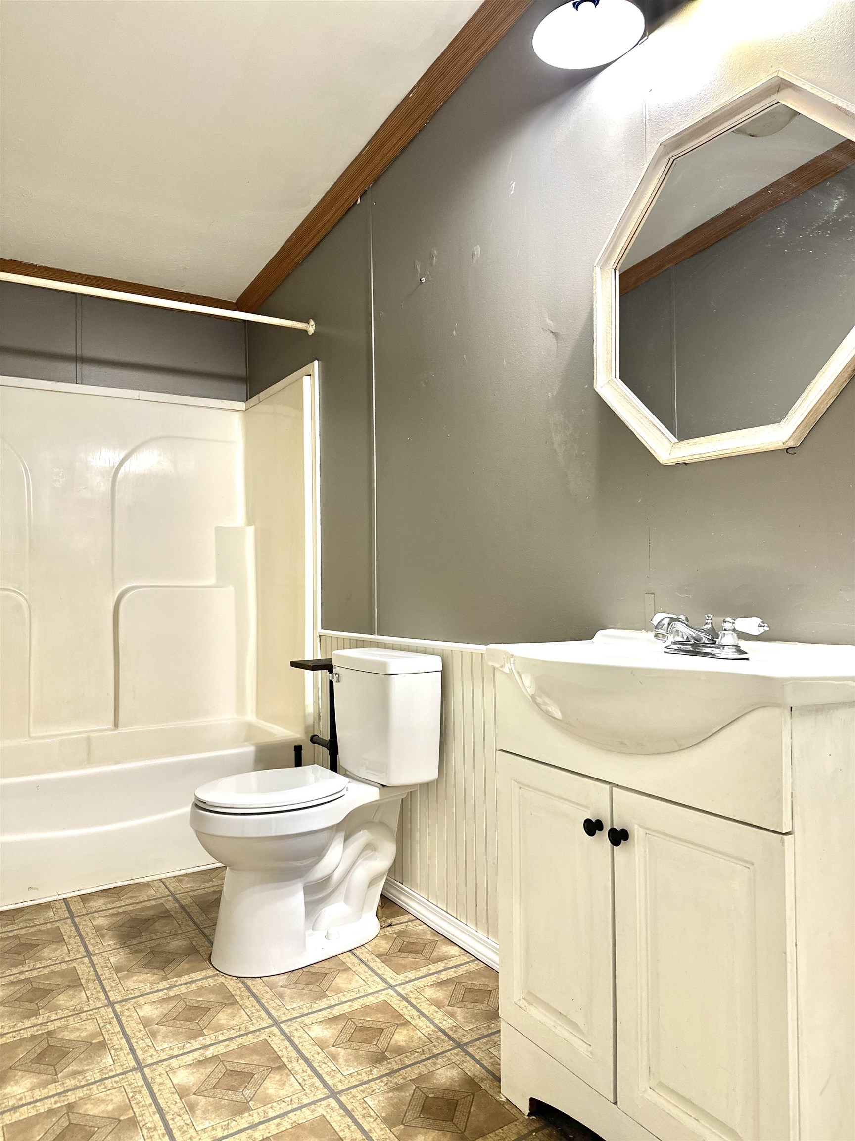 Full bathroom with vanity, shower / bath combination, toilet, and ornamental molding