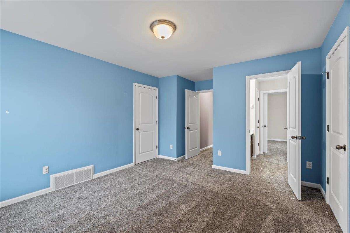 Unfurnished bedroom with carpet