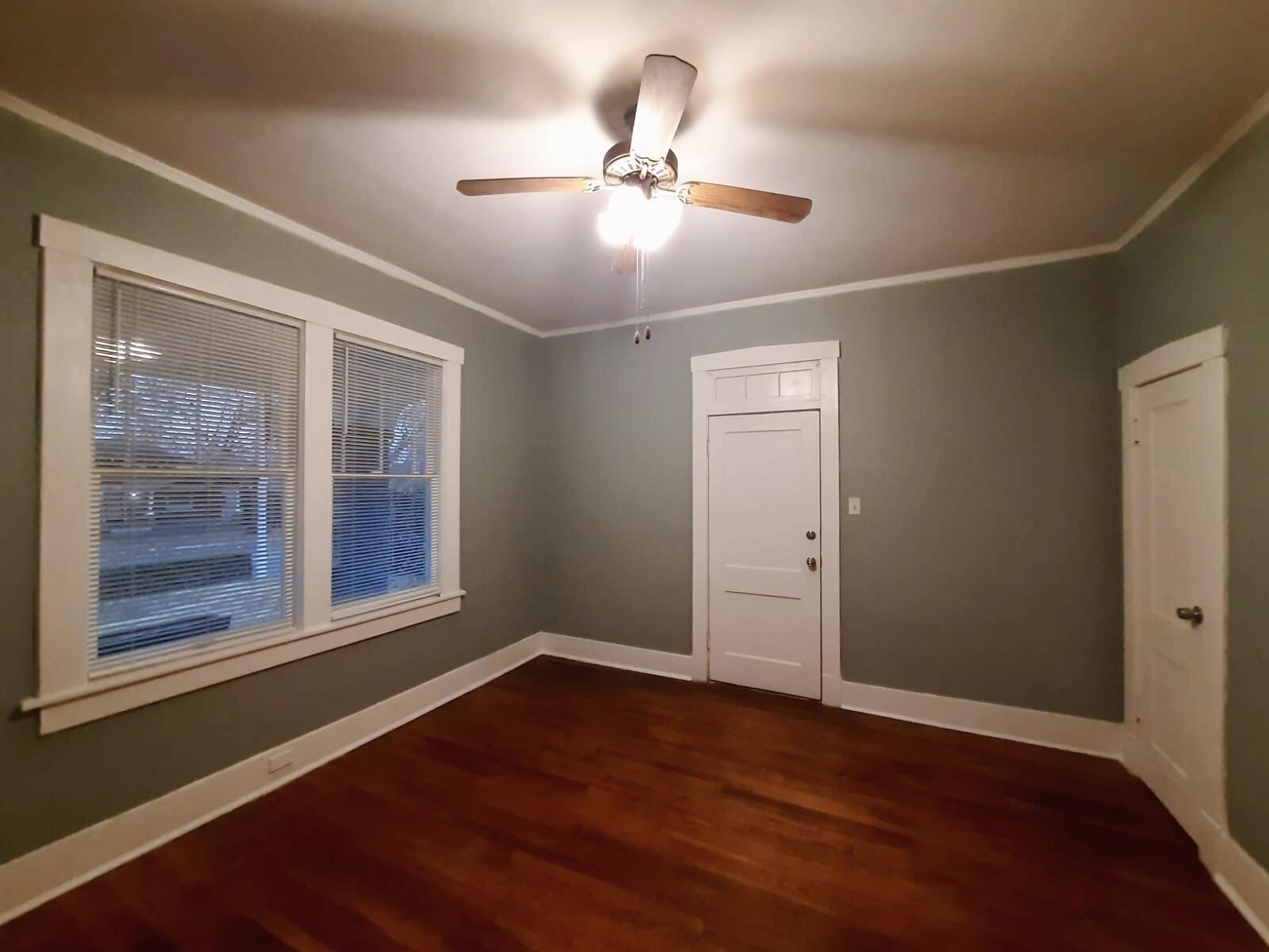 Unfurnished room with ceiling fan, dark wood-type flooring, and ornamental molding