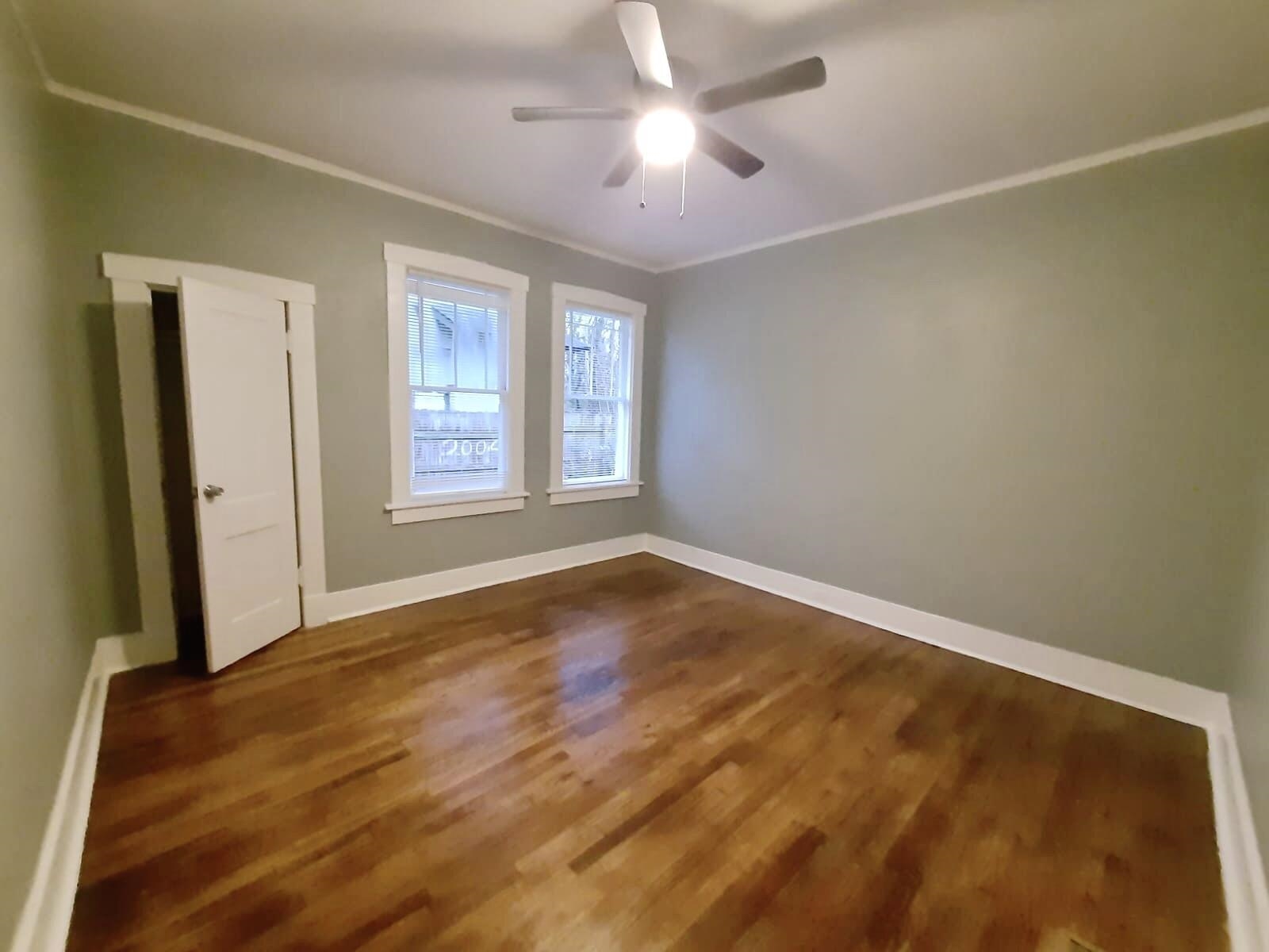 Unfurnished room featuring ceiling fan, wood-type flooring, and ornamental molding