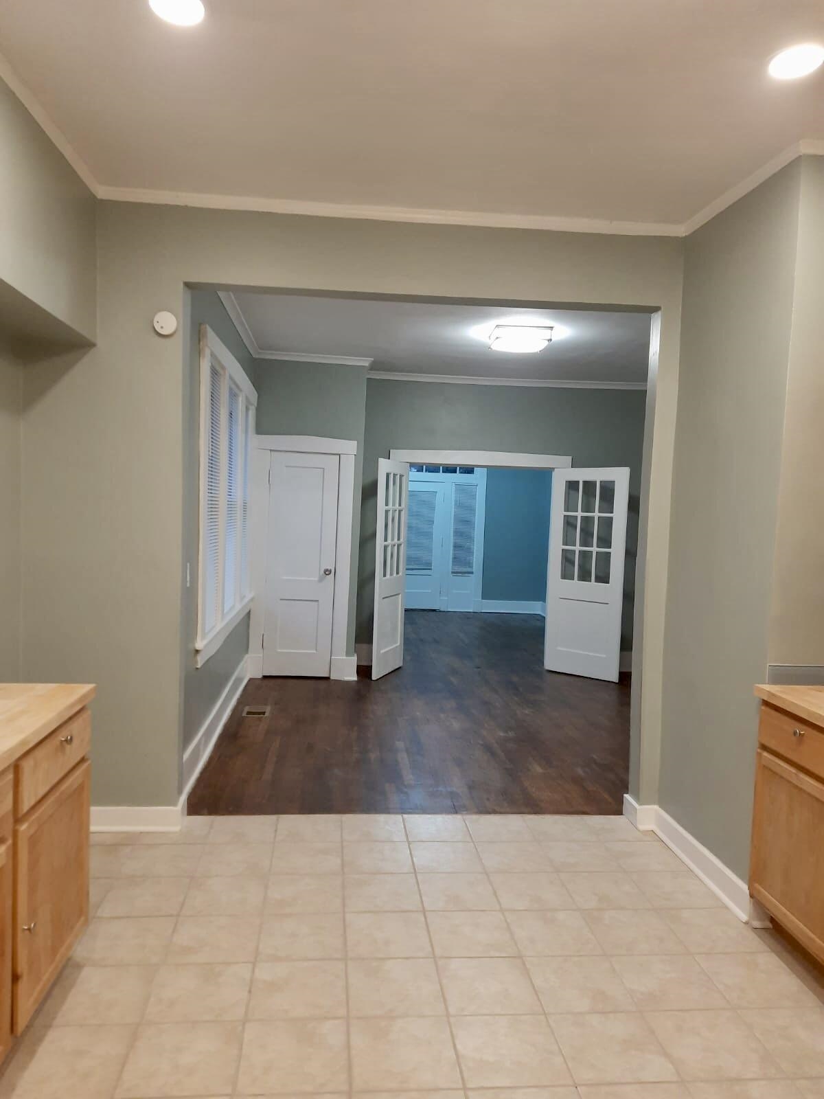 Interior space with light wood-type flooring and crown molding