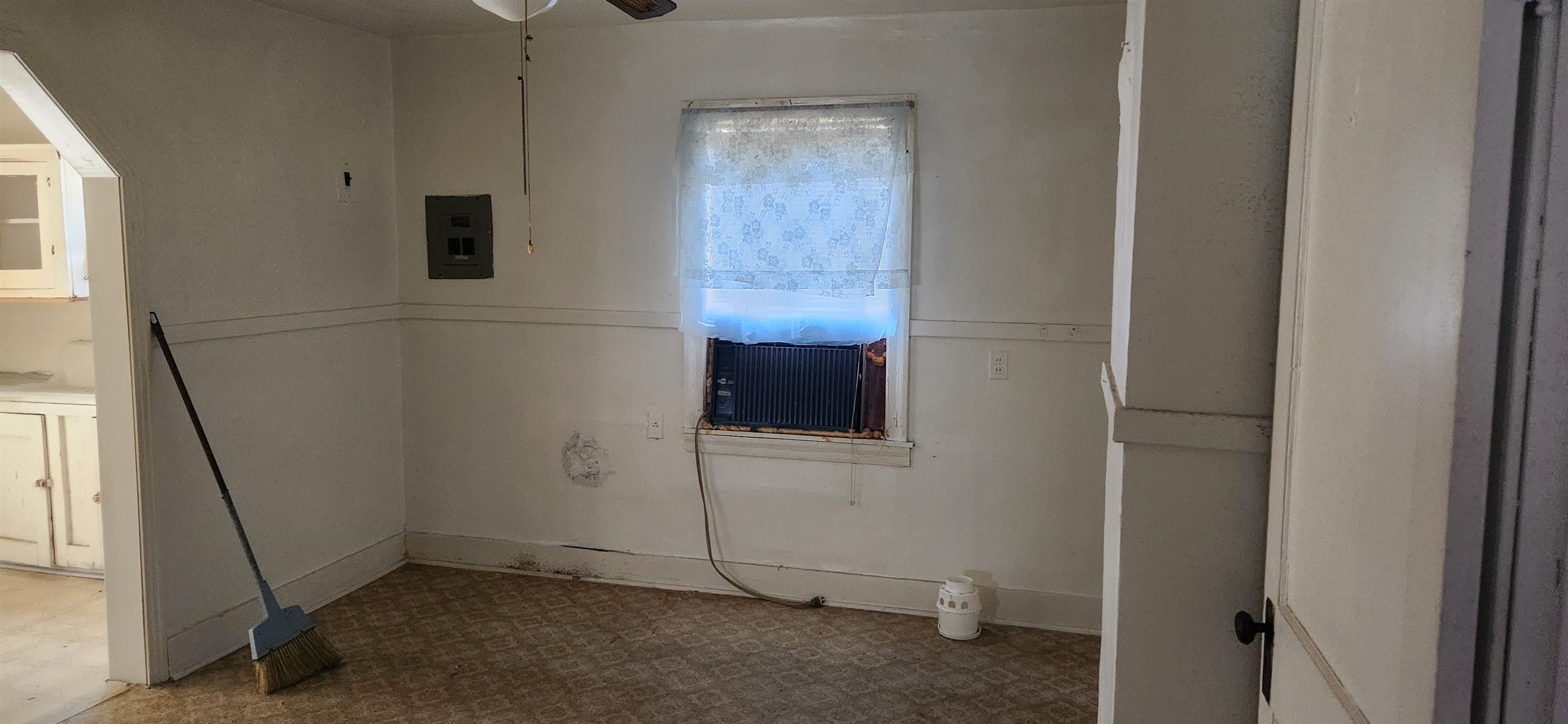 Spare room with electric panel and ceiling fan