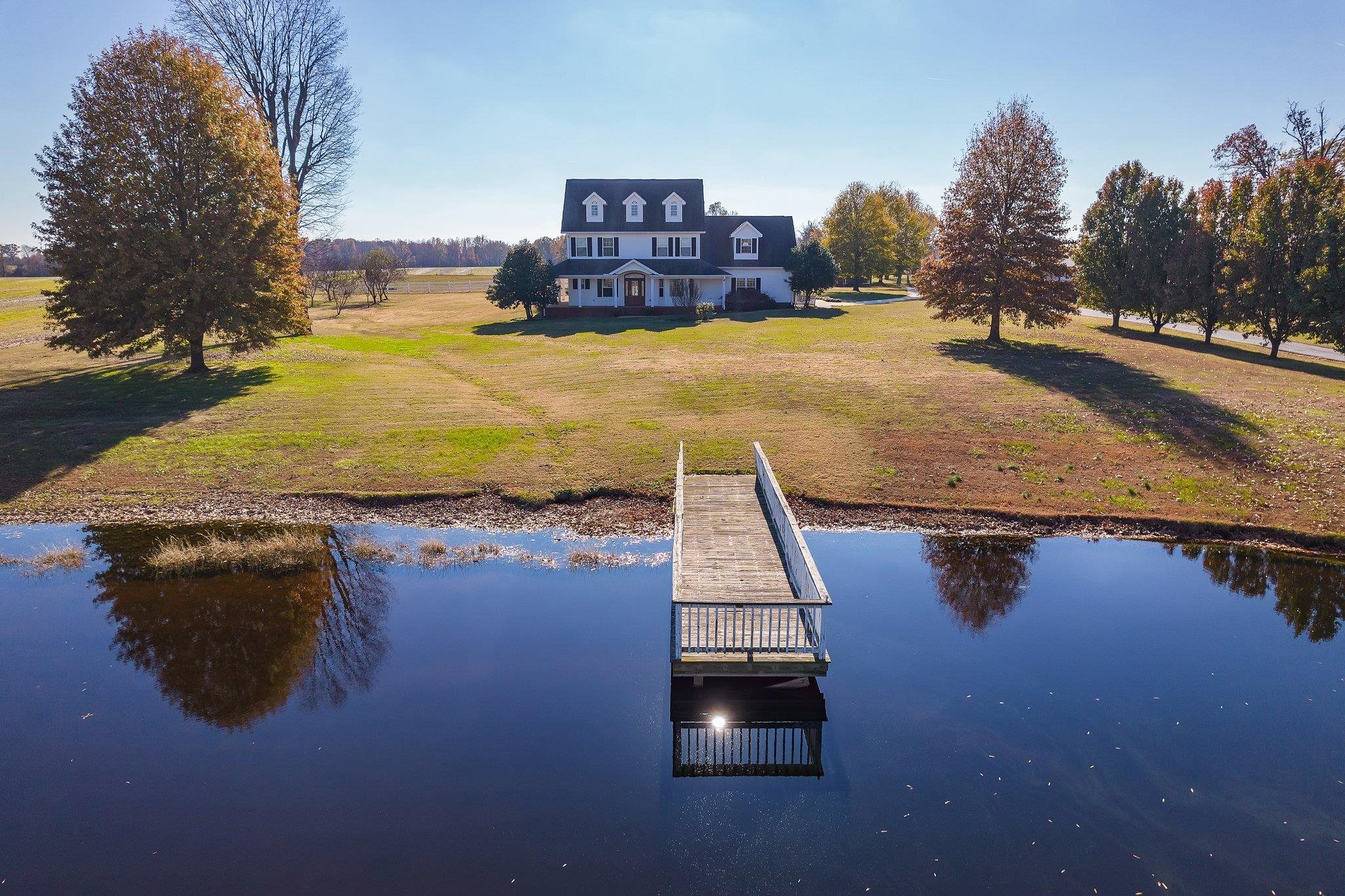 Dock area featuring a yard and a water view