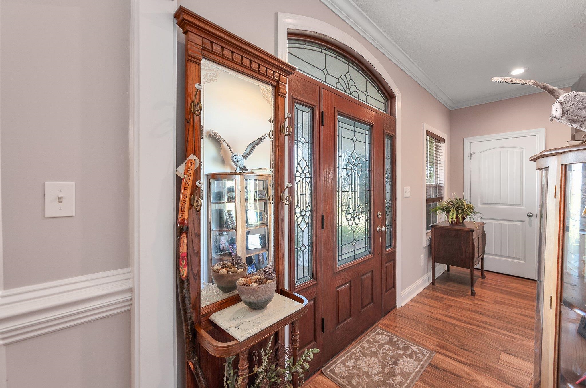 Entrance foyer featuring wood-type flooring and ornamental molding