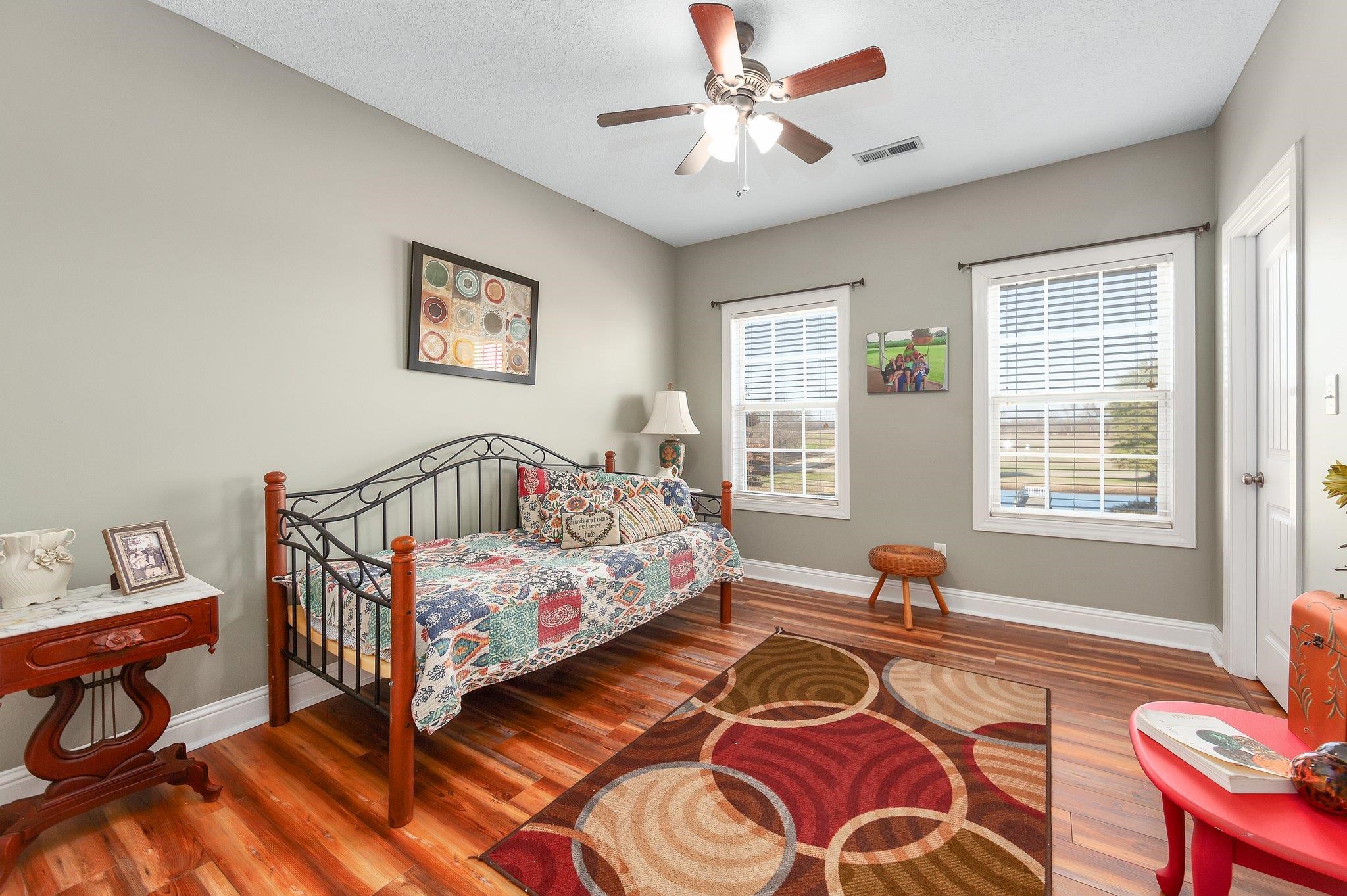 Bedroom with hardwood / wood-style flooring and ceiling fan
