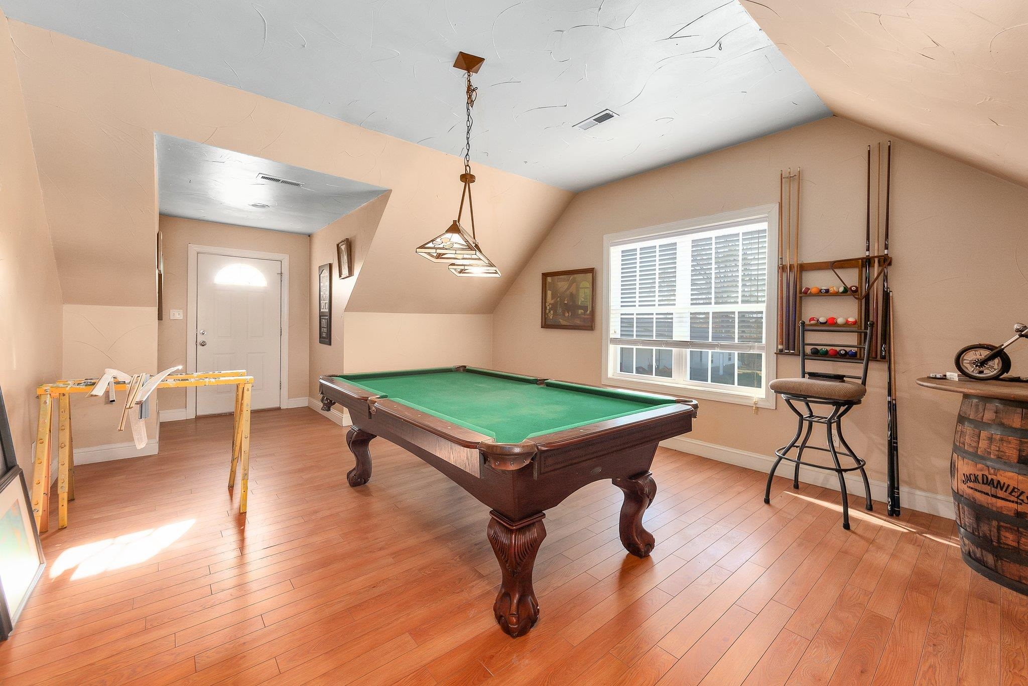 Rec room featuring hardwood / wood-style flooring, lofted ceiling, and pool table