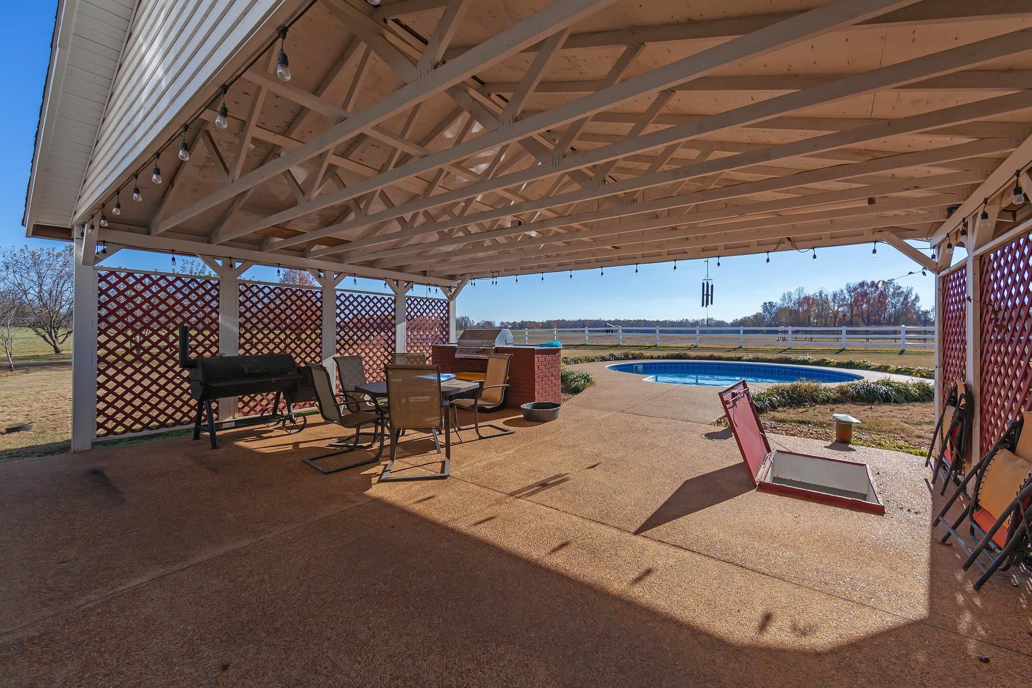 View of patio / terrace featuring a fenced in pool and a grill