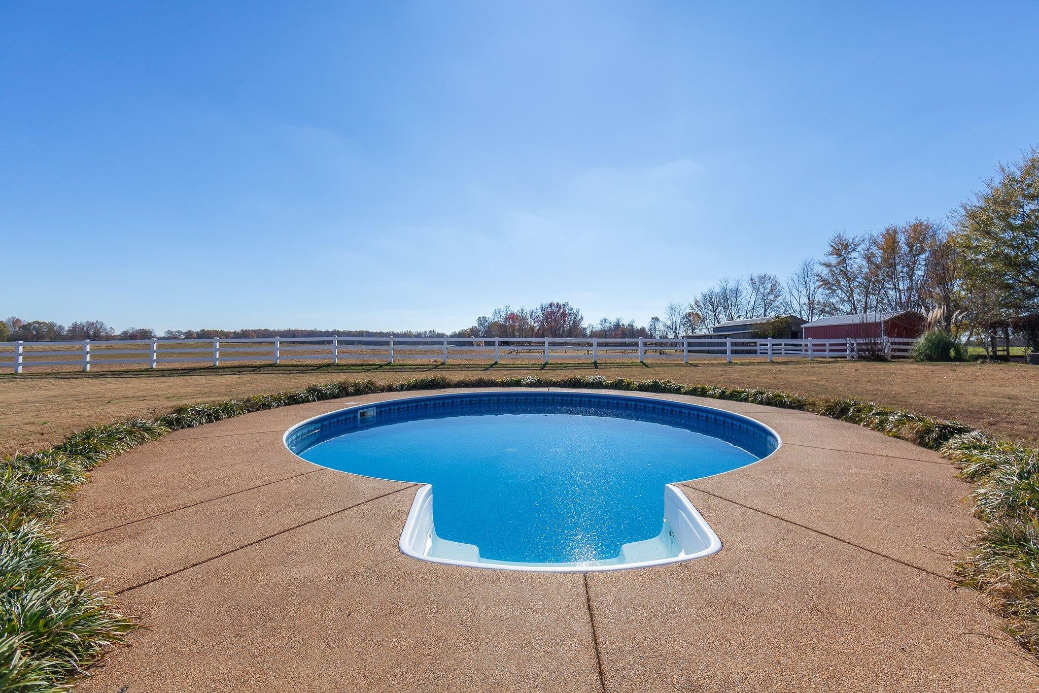 View of pool featuring a rural view and a patio